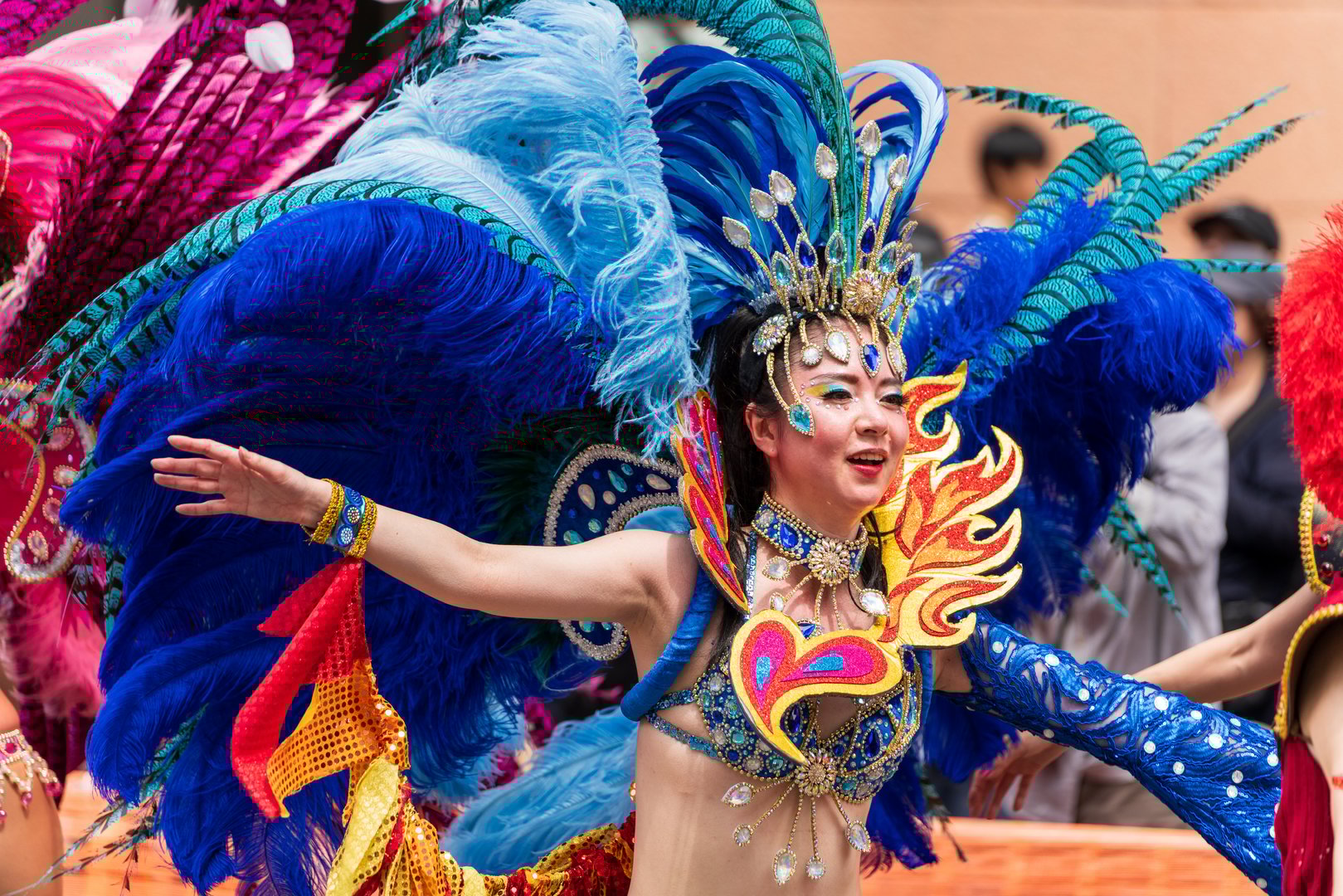 Kobe, Hyogo, Japan - May 18 2025 : Dancers in vibrant samba costumes performing enthusiastically on Samba Street at the 52nd Kobe Festival.