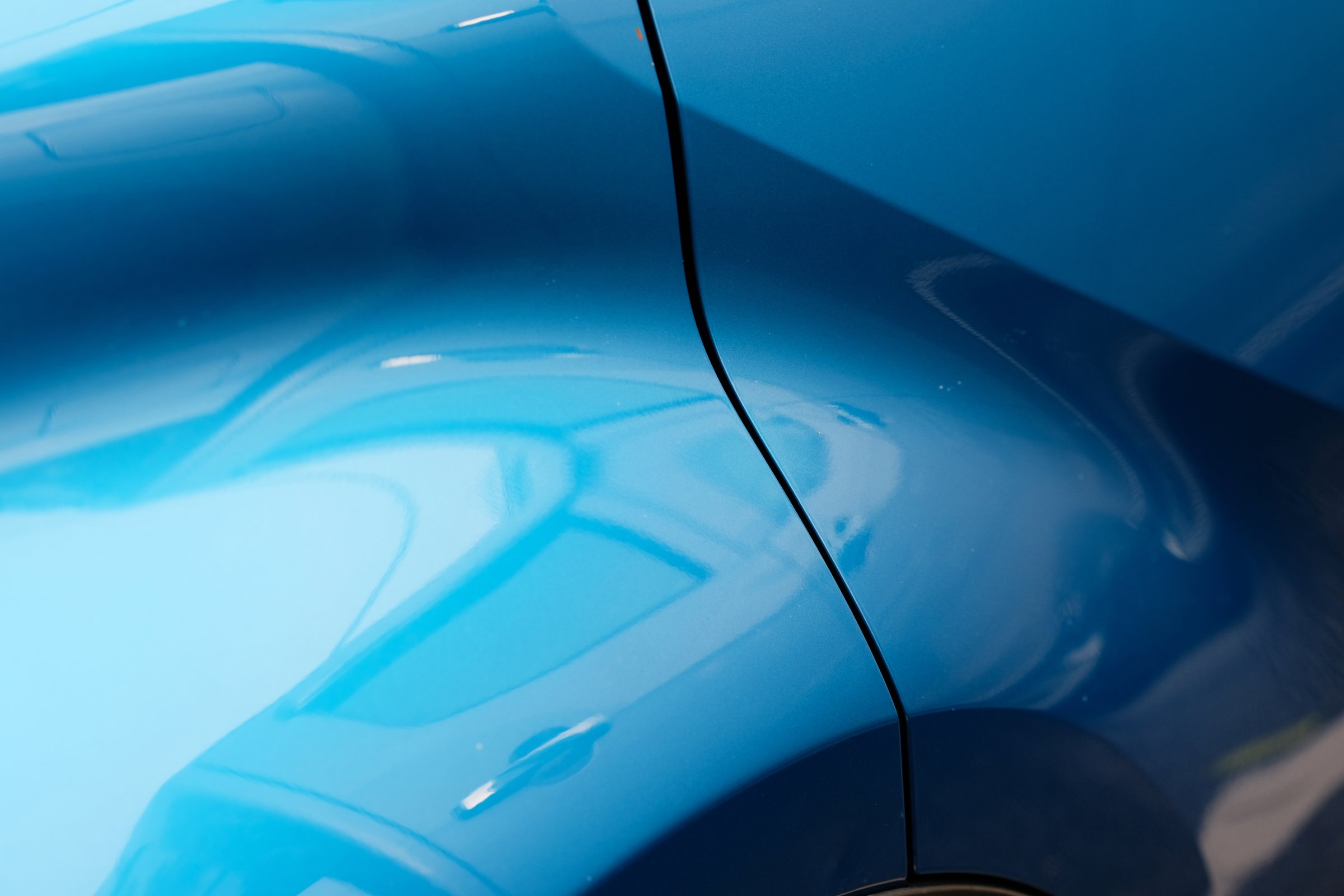 the back of the blue car