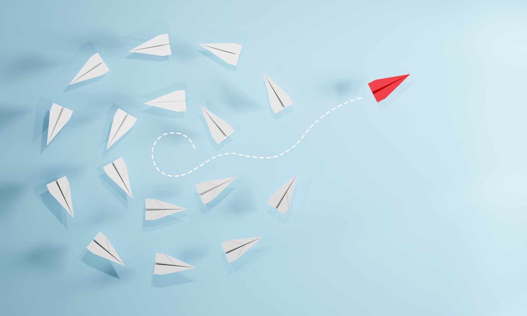 Red paper plane flying away from a group of white planes on blue background. Concept of leadership, innovation, individuality, thinking different, and unique direction.