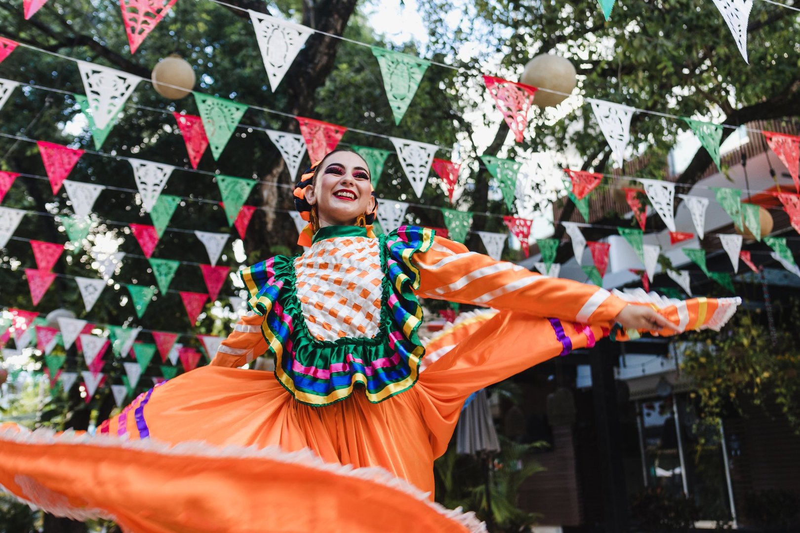Latin woman dancer wearing traditional Mexican dress traditional from Guadalajara Jalisco Mexico Latin America, young hispanic people in independence day or cinco de mayo parade or cultural Festival