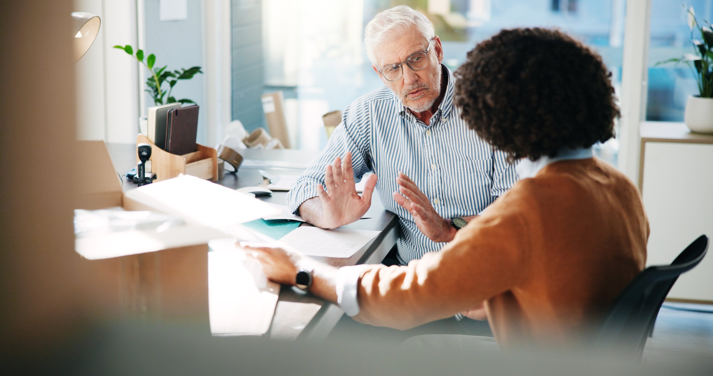 Small business, team and men planning logistics, shipping and training with manager in warehouse. Talking, distribution and discussion for delivery, ecommerce inventory and coaching for supply chain