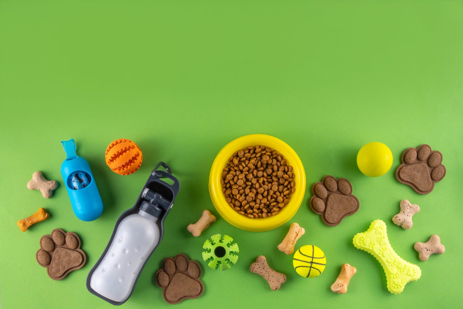 Flat lay composition with food, snacks, toys and accessories for dog and cat on bright background. Pet care, dog shopping and sale concept top view copy space