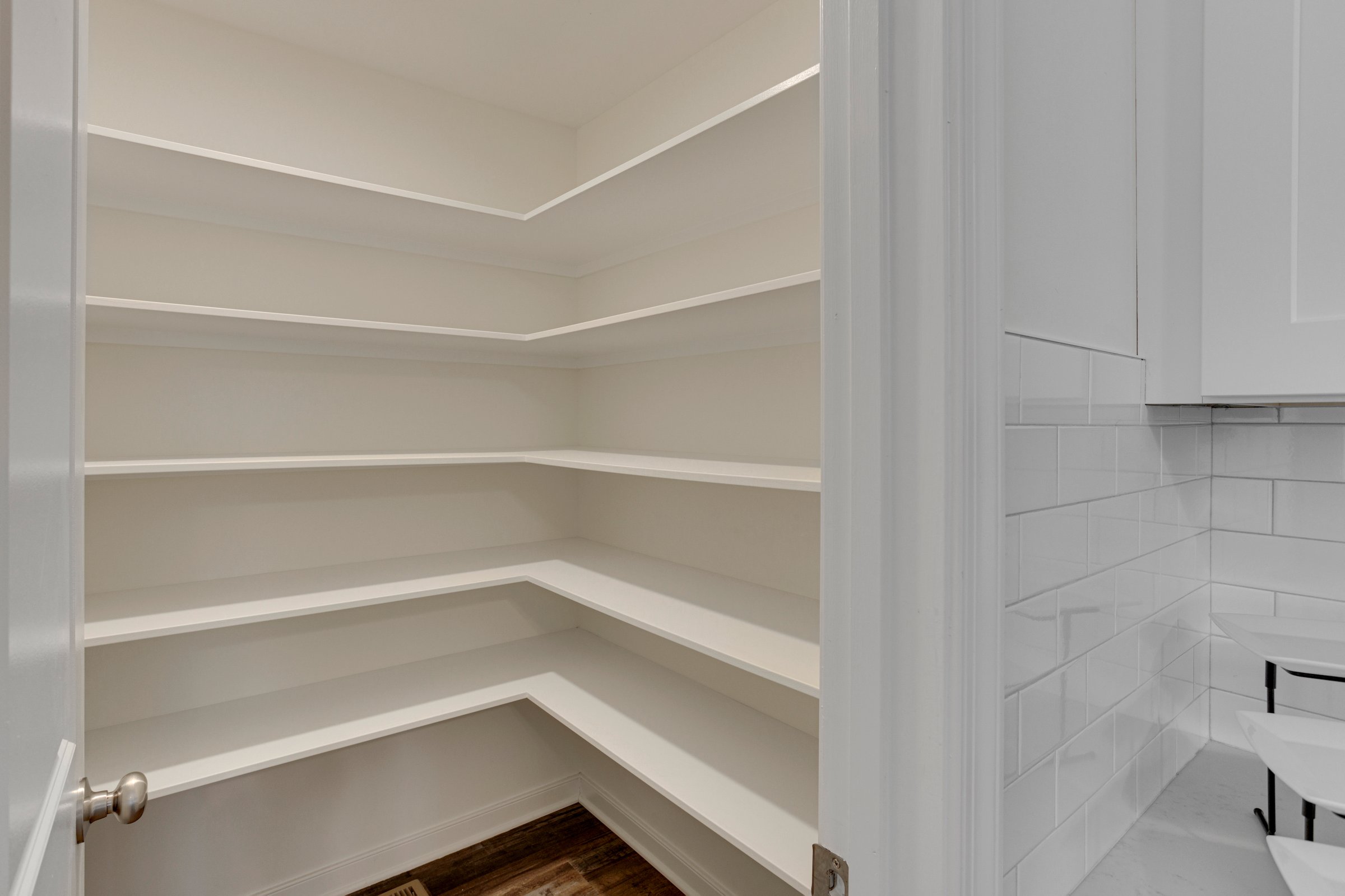 Empty pantry with white shelving