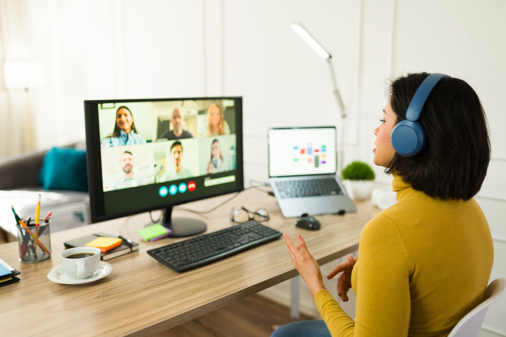 Young entrepreneur attending a virtual meeting with her team while working remotely from home