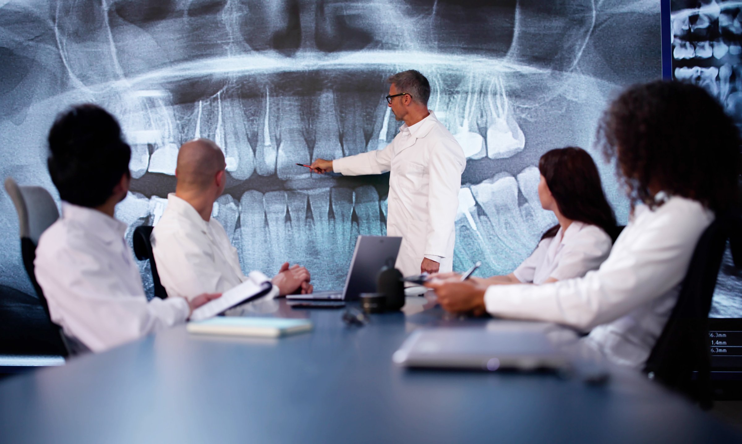 Dentist Doctor Looking At Teeth Xray Using Computer Software