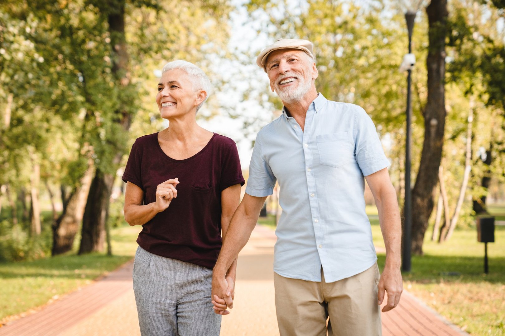 Senior couple walking in park enjoying retirement