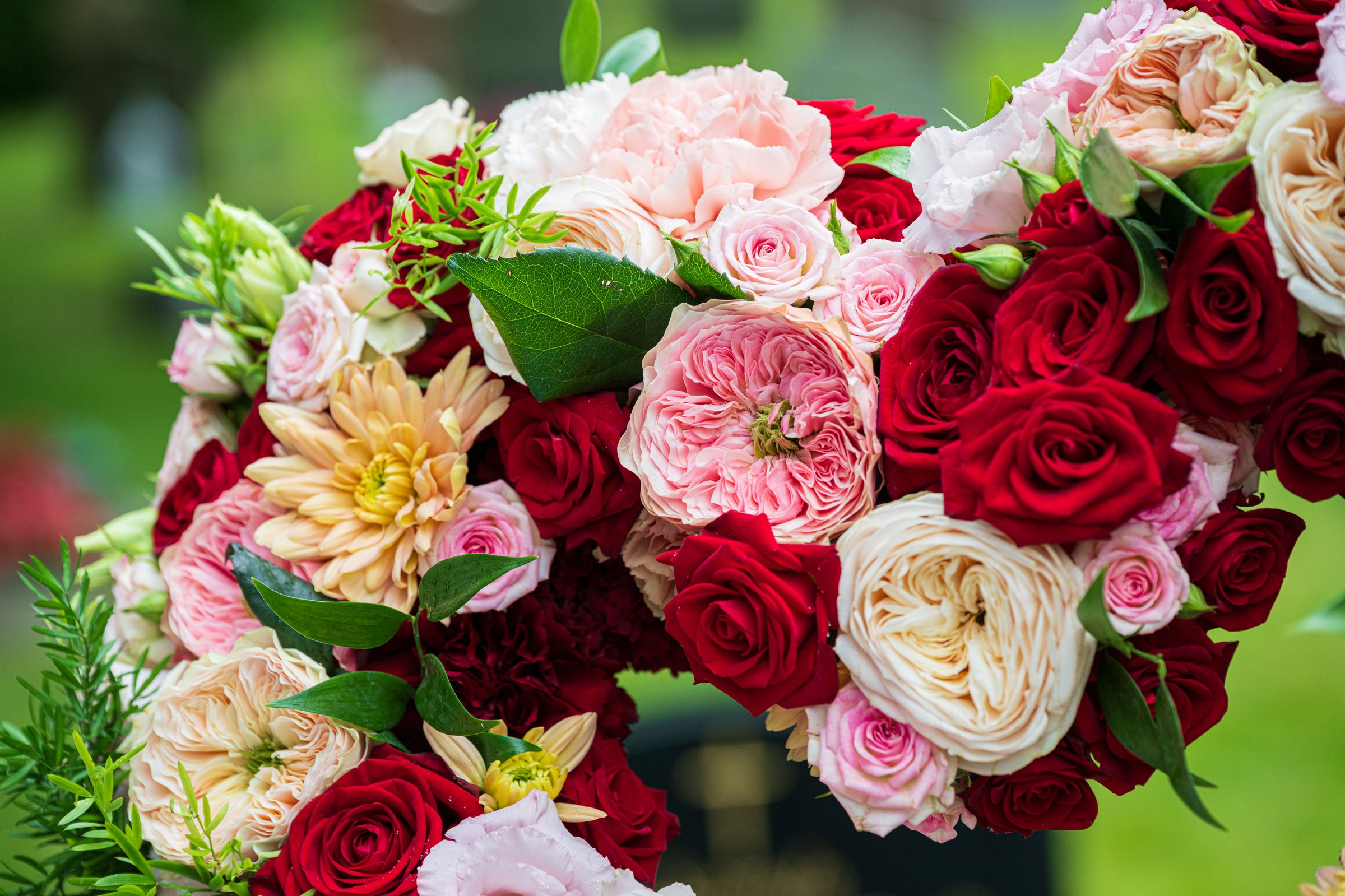 Romantic floral heart arrangement with roses and peonies.