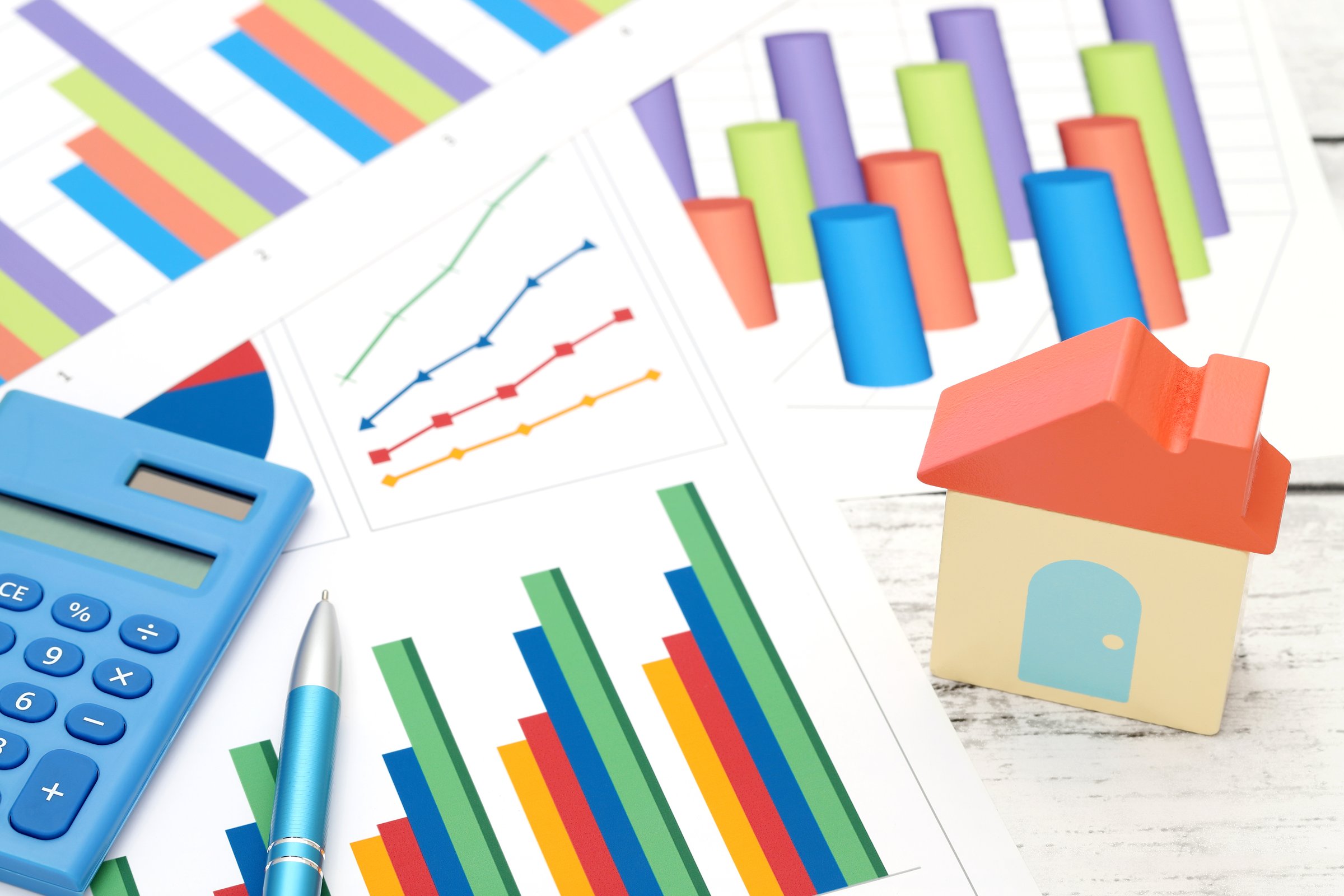 color chart printed documents with toy house on the table