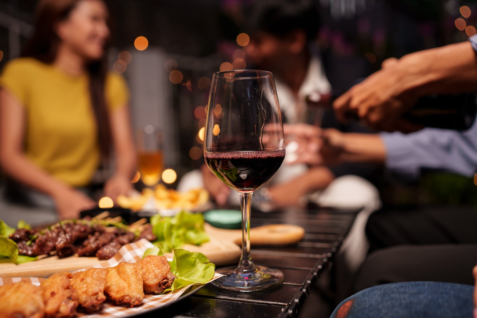 Group of people meeting for drinks celebrating and showing each other good times happily