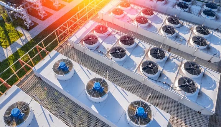 Hvac technician performing air conditioner condenser unit maintenance inspection outdoor on the rooftop. 24 hours emergency repair service for air conditioning breakdowns and failures. Home insurance.