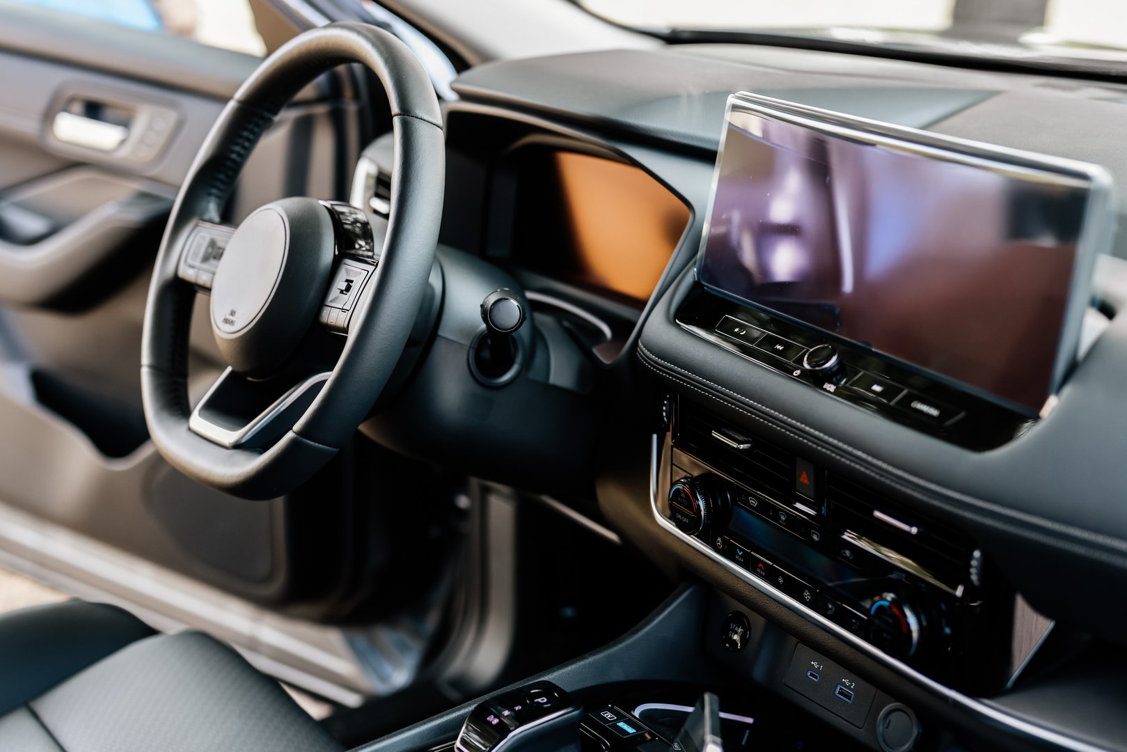 Concept of stylish design, shopping, and car parts. Close-up of a car steering wheel in a modern new car. The interior of a stylish new car.