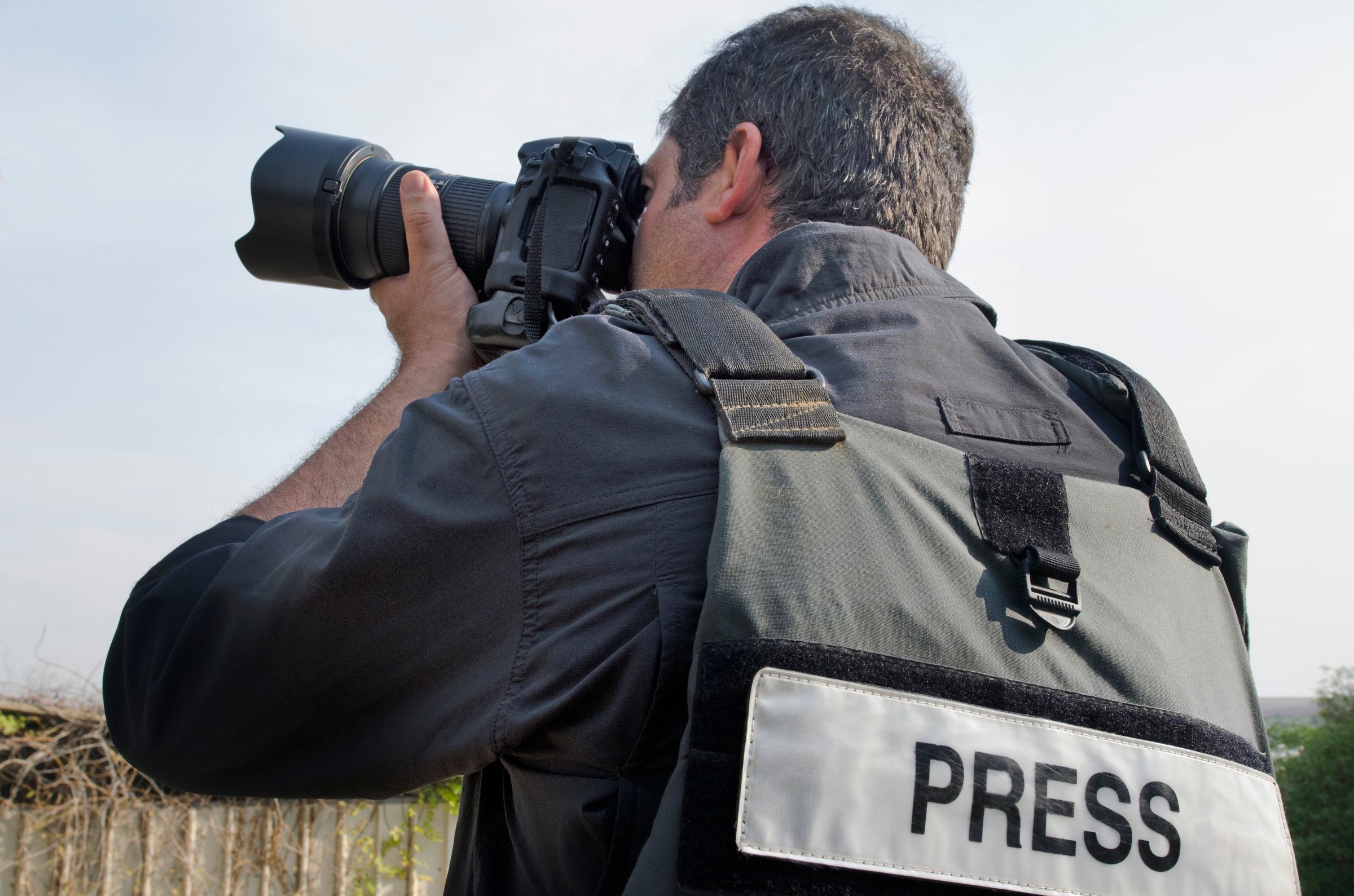 A press photographer takes photos with a professional camera