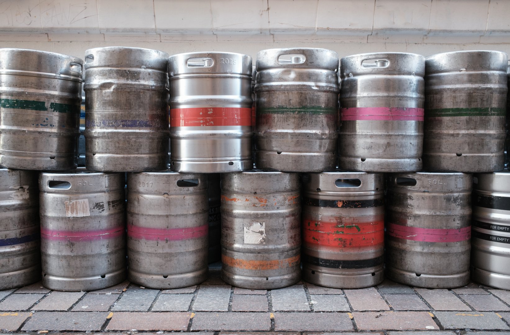A Stack Of Industrial Metal Beer Kegs Or Barrels Outside A Bar Or Pub