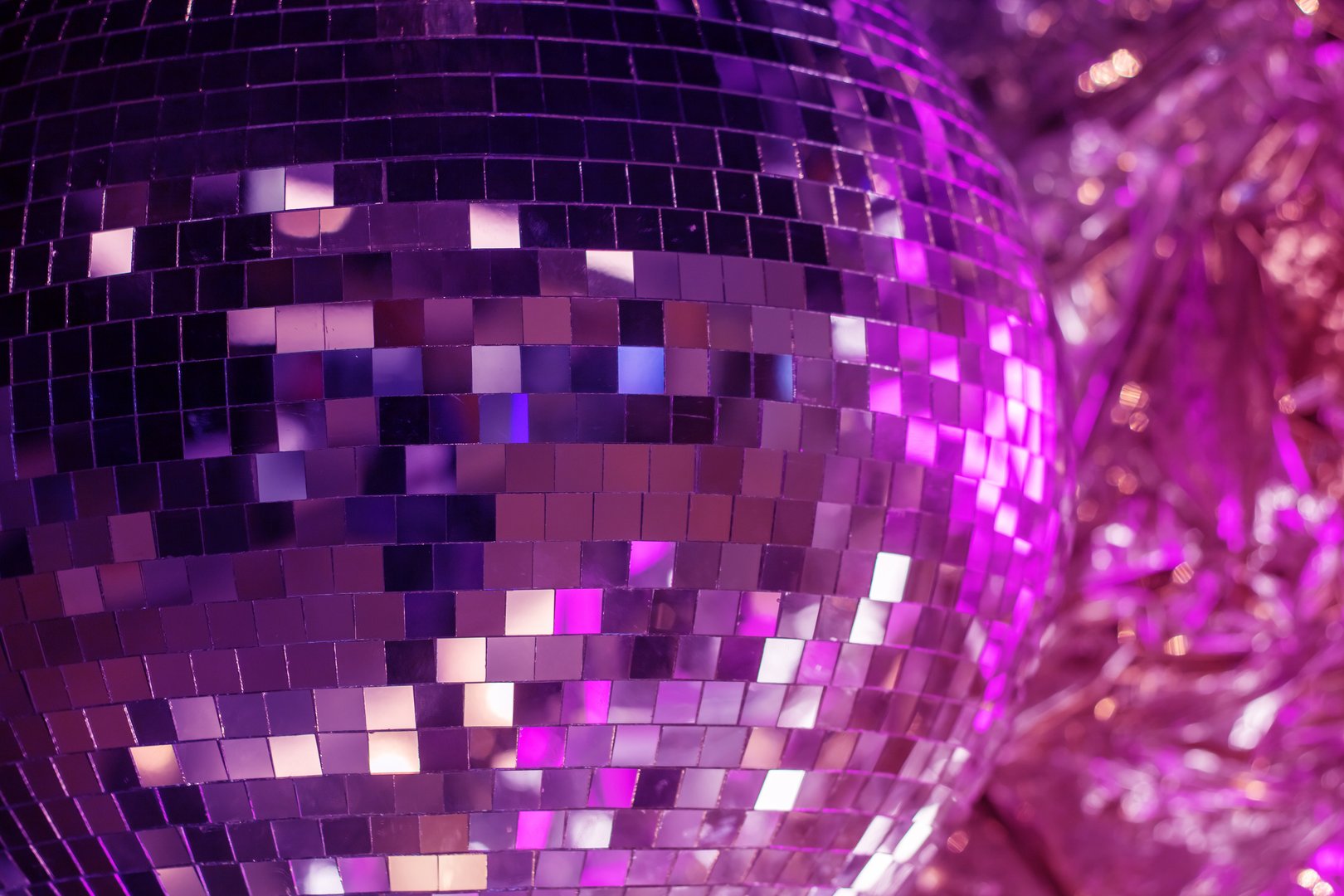 Shiny disco ball in pink tones close up