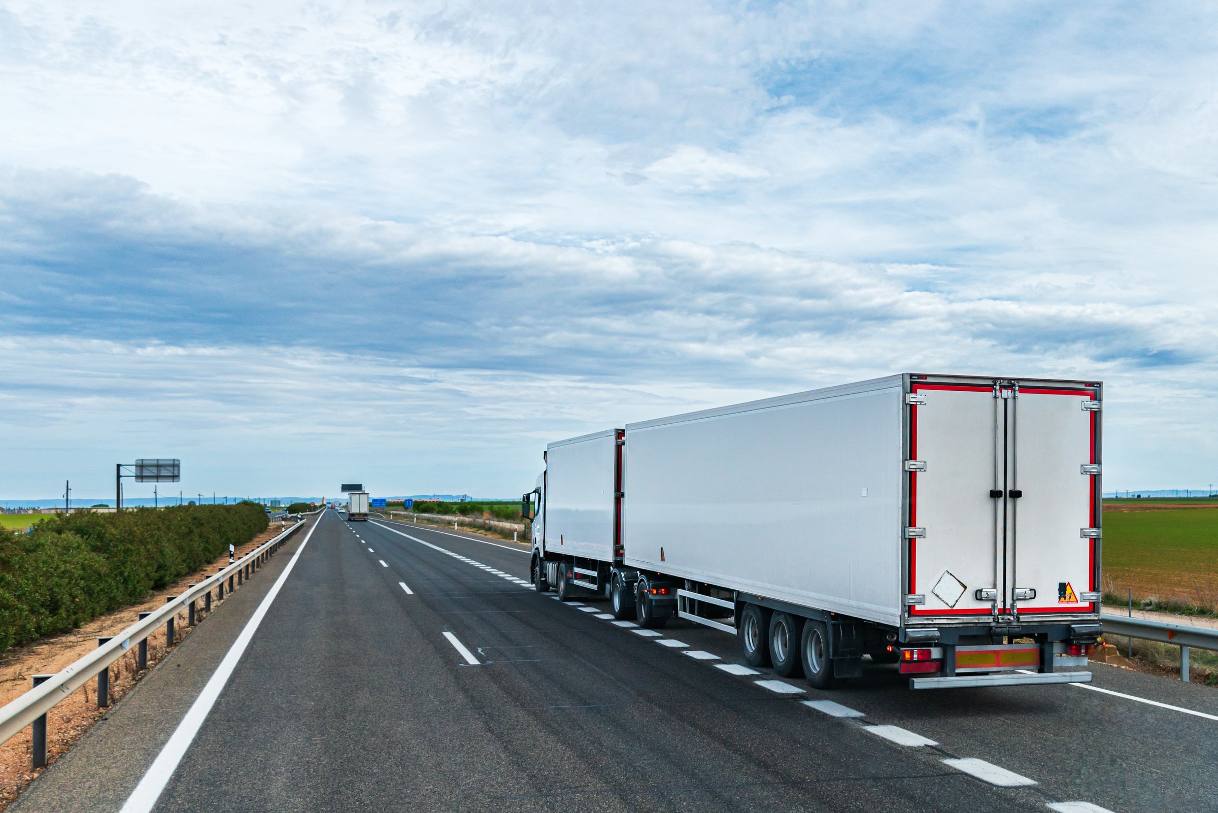 Truck with refrigerated semi-trailer on highway