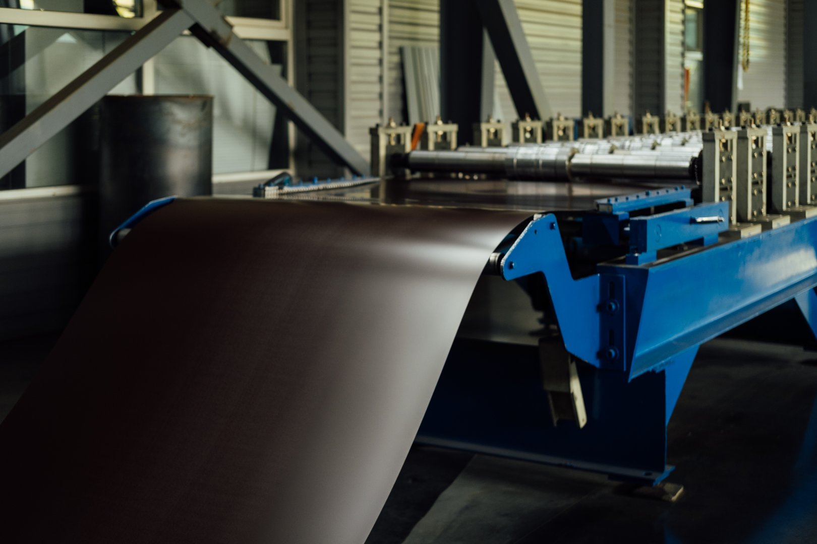 Industrial equipment for working with coil metal. Decoiler holds and unwinds metal coil. Slitting or cut-to-length line - cut coil metal into strips