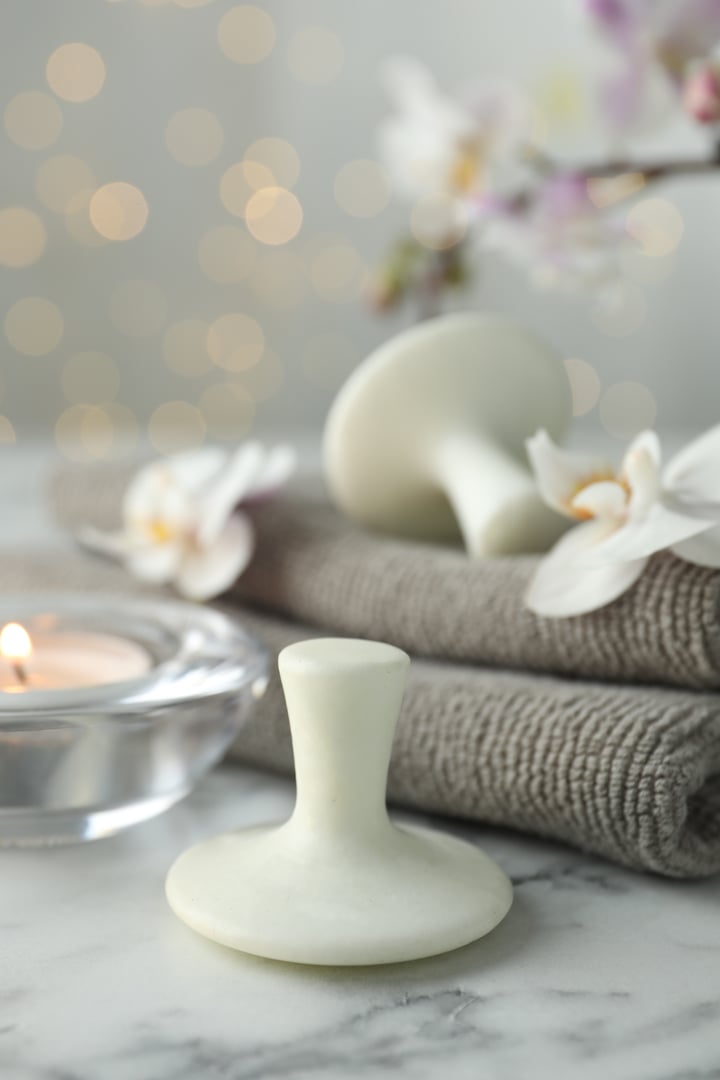 Spa stones, orchid flowers, towels and burning candle for relaxation