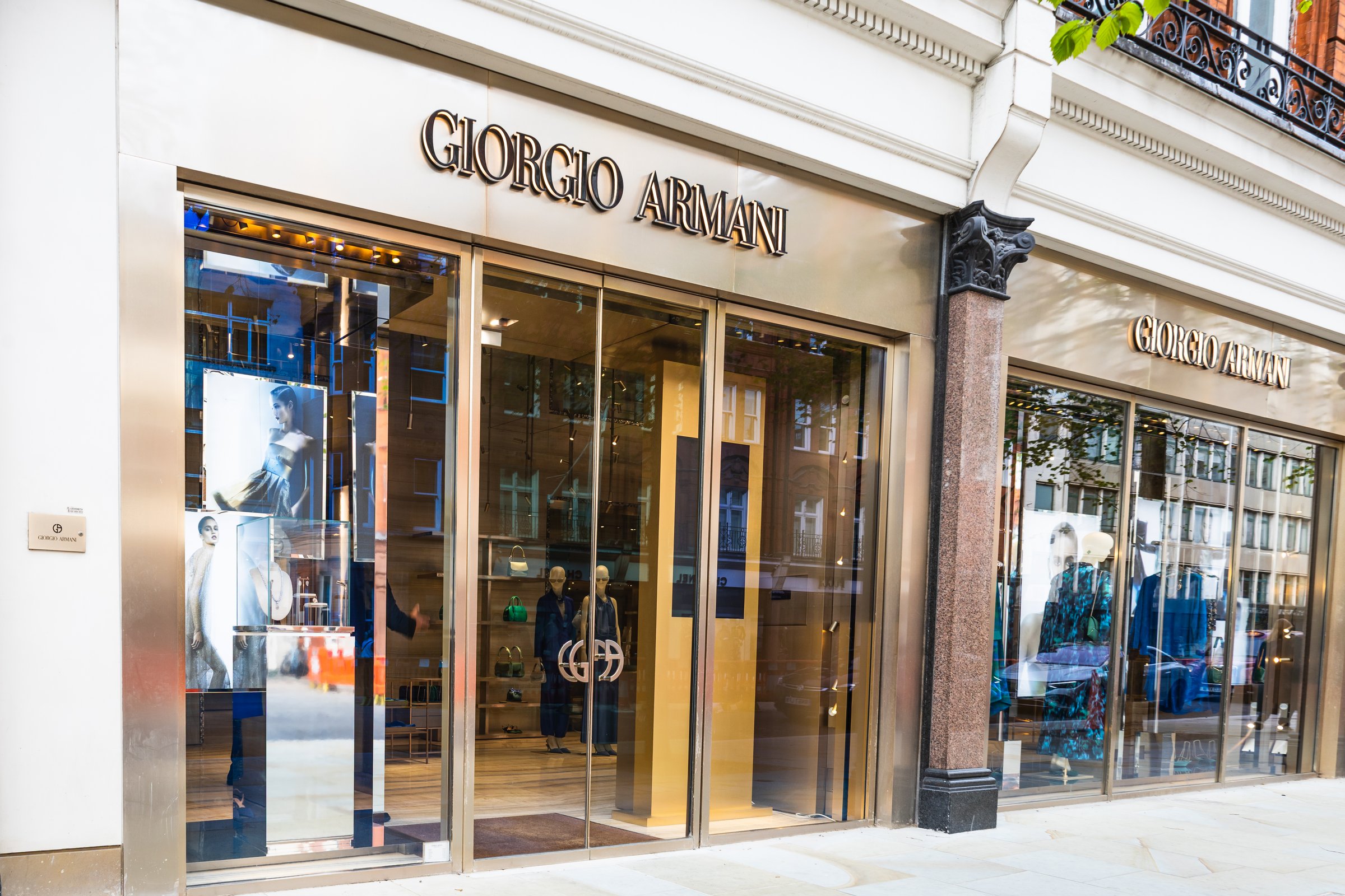 Chic Giorgio Armani store highlighting premium fashion pieces in a modern, artistic window display. London, UK, 6 April 2024