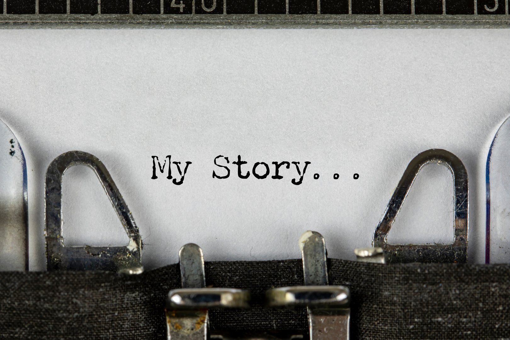 My Story, storytelling and once upon a time typed words on a vintage typewriter. Close up. Who are you? Question written under torn paper.