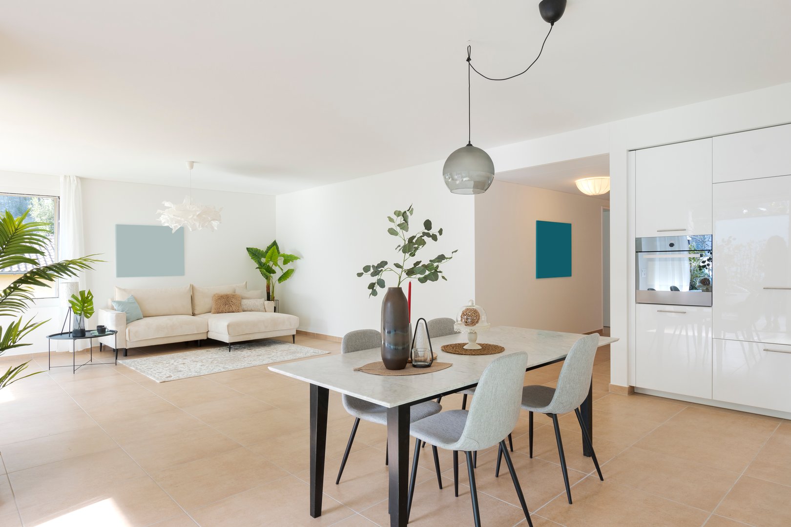 Interior of lounge and dining room. No one within that space. Modern flat, inside one sees a marble table and a sofa. Everything is tastefully furnished. Very Swiss style, cosy but cold everything perfect.