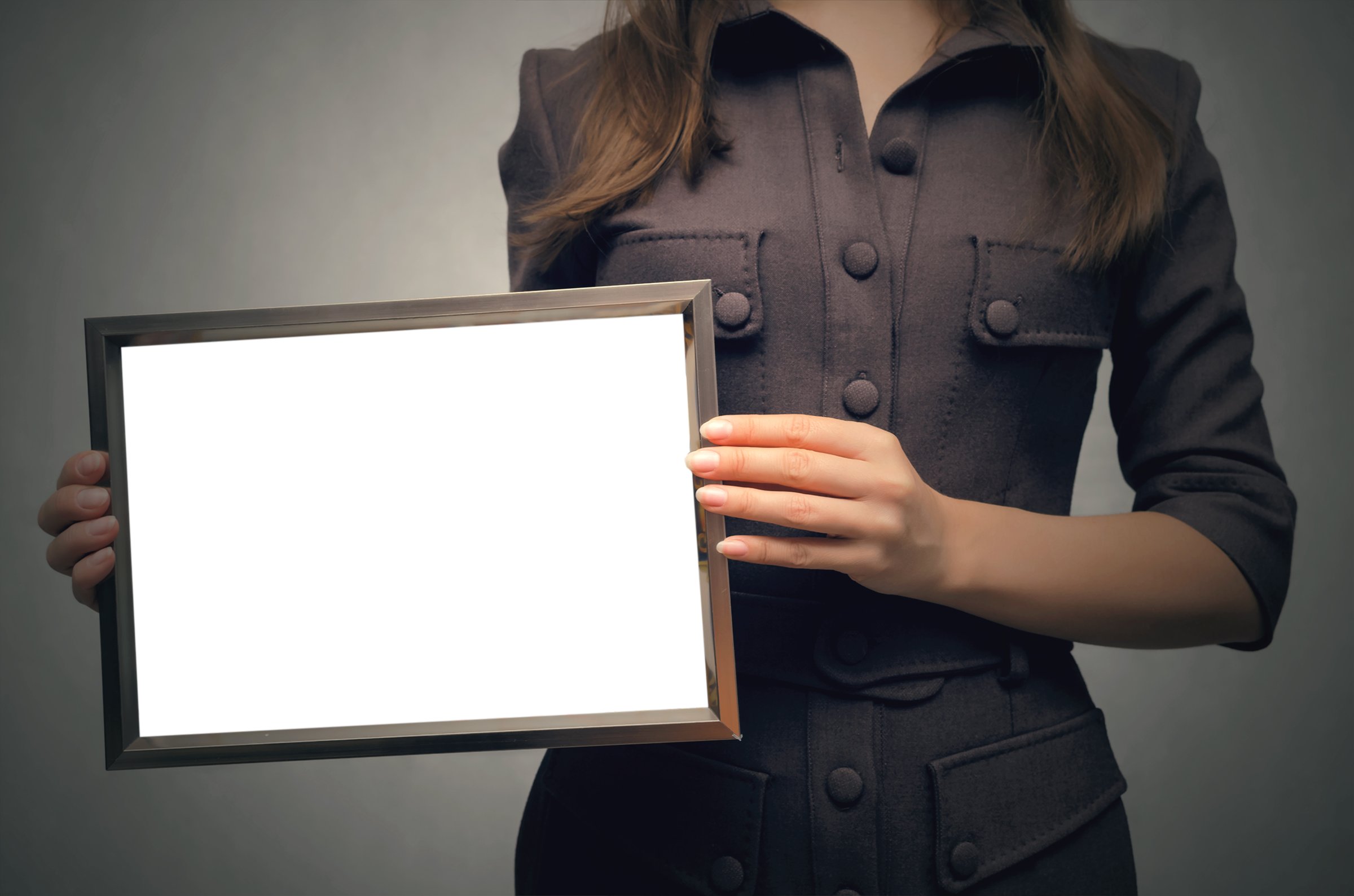 Grateful letter. Gratitude concept. Accolade. Thank letter. Special offer. Young business woman in strict dress holding in hands empty blank photo frame. Appreciation document.