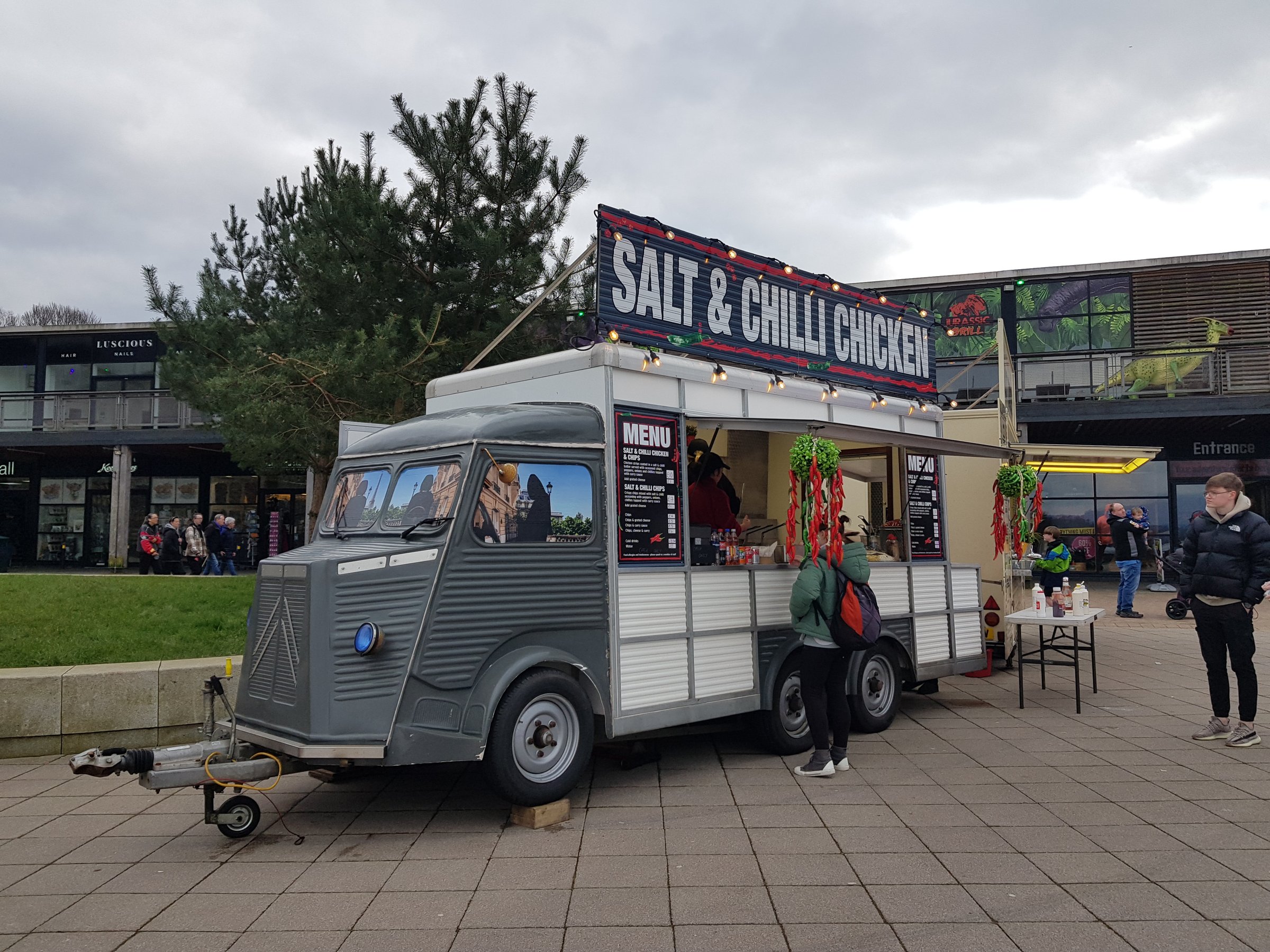 A person is buying  food from a food truck at a market day at Loch Lomond Shores, Balloch, Loch Lomond, Glasgow Scotland England