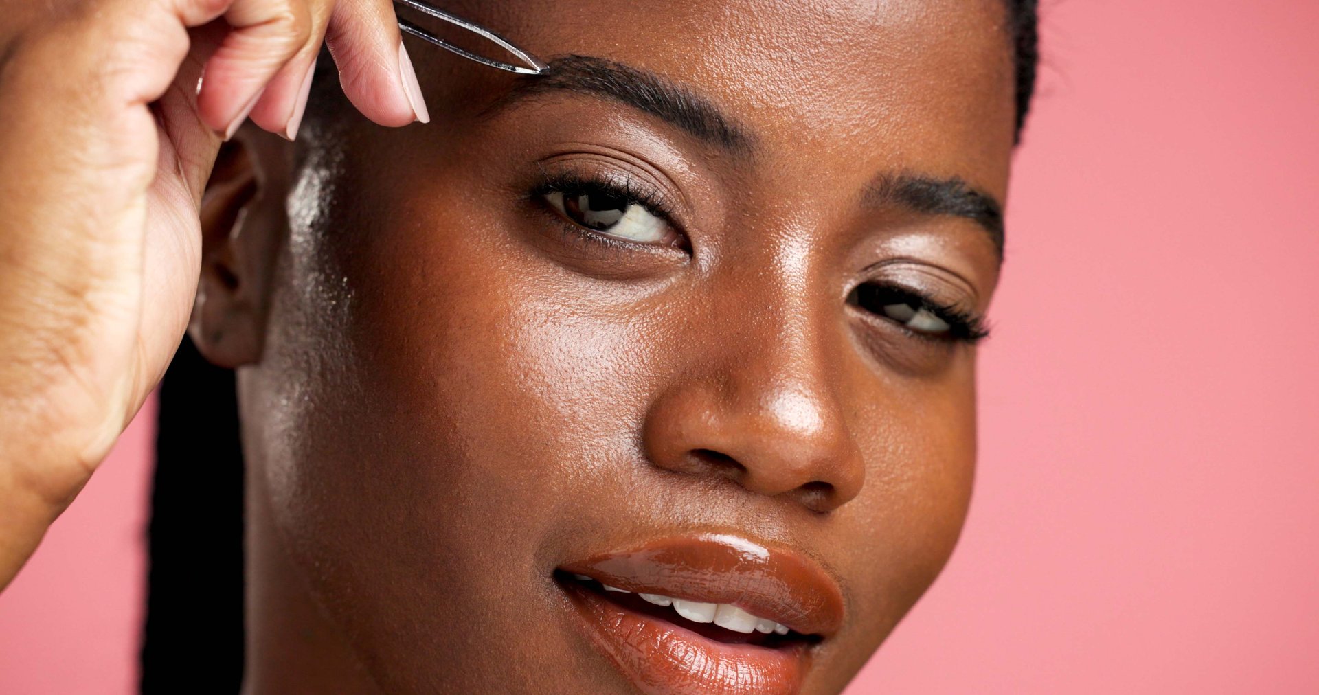 Tweezer, eyebrow and portrait of black woman in studio for hair removal, grooming and self care. Beauty maintenance, growth and shaping with female person on pink background for tools and face