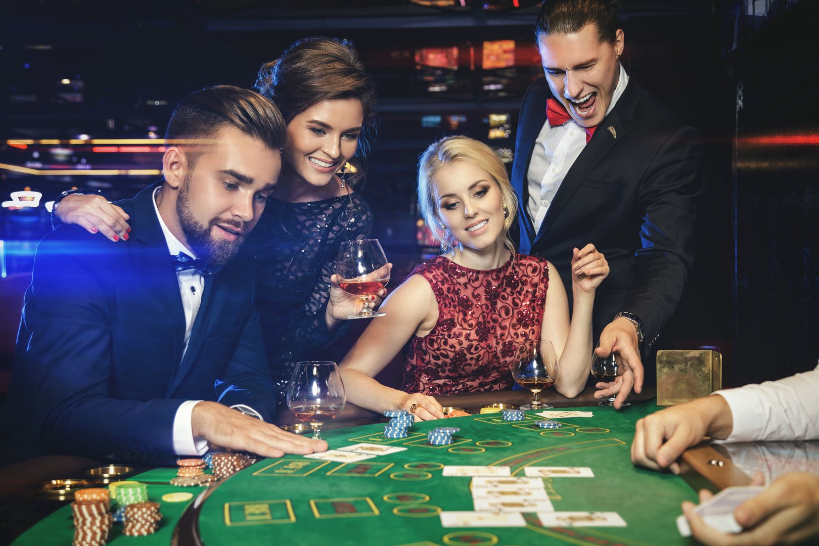 Group of young rich people is playing poker in the casino