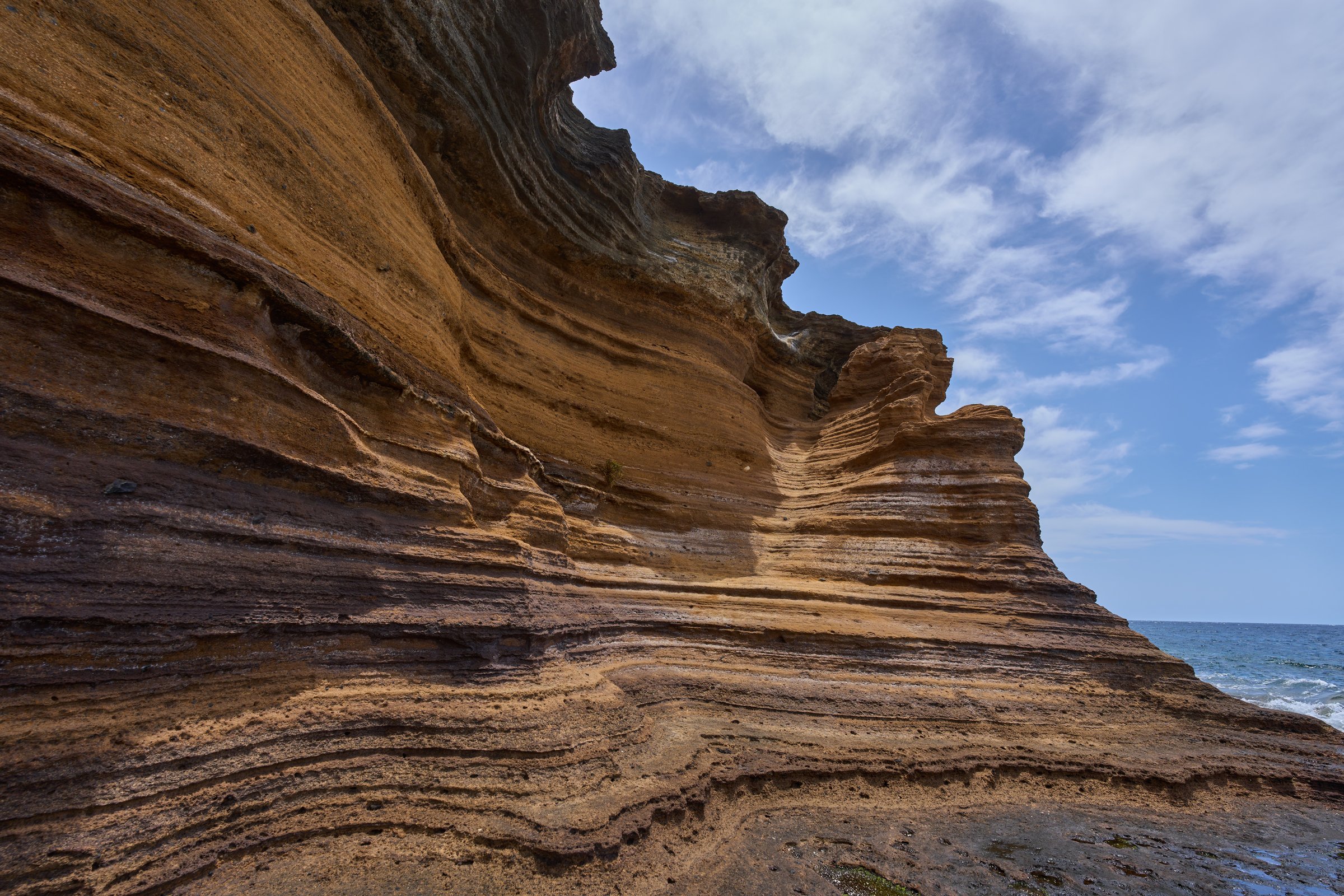 Eroded volcanic sandstone canyon walls with layered textures at Playa de Montaña Amarilla in Tenerife
