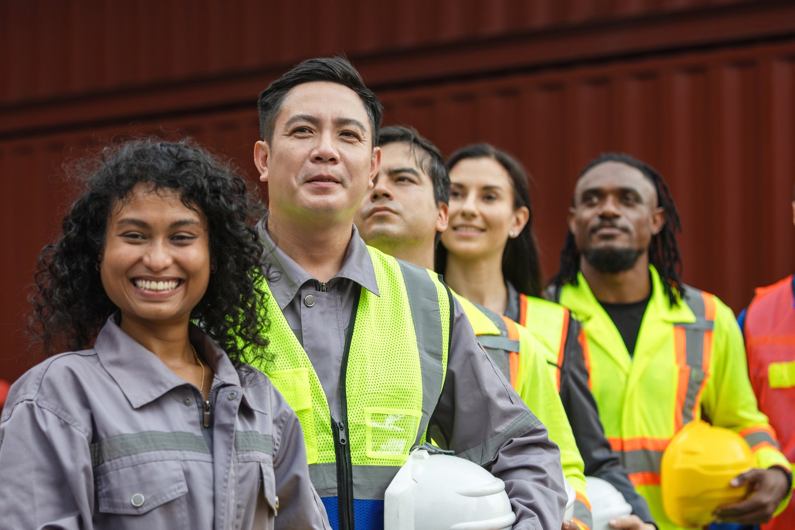 Diverse Team of Construction Workers and Engineers at a Job Site, Group of Multi Ethnic Industrial Professionals at Shipping Yard, Collaboration and Diversity in the Modern Workforce