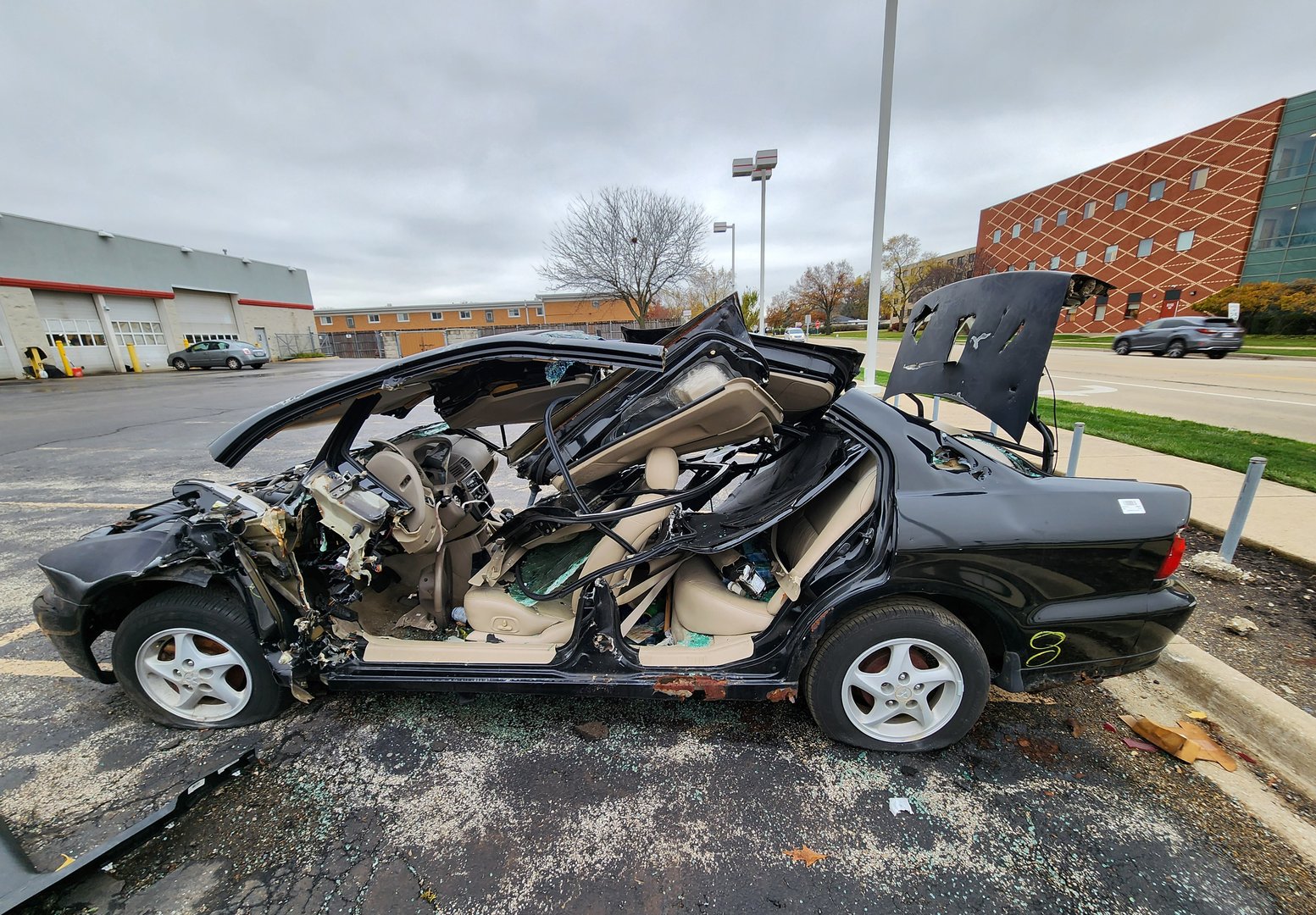 Chicago, USA - November 11, 2024: Mitsubishi crashed in car accident. Mitsubishi car crash and damage. Damage of car in accident. Car crash insurance. Broken Mitsubishi, side view.