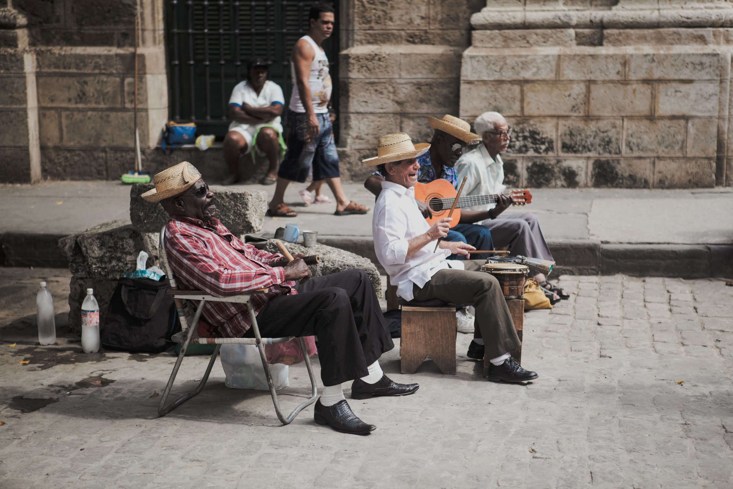 Havana, Cuba - March 11, 2024: A vibrant group of musicians entertain passersby on a lively street in Havana with traditional Cuban music.