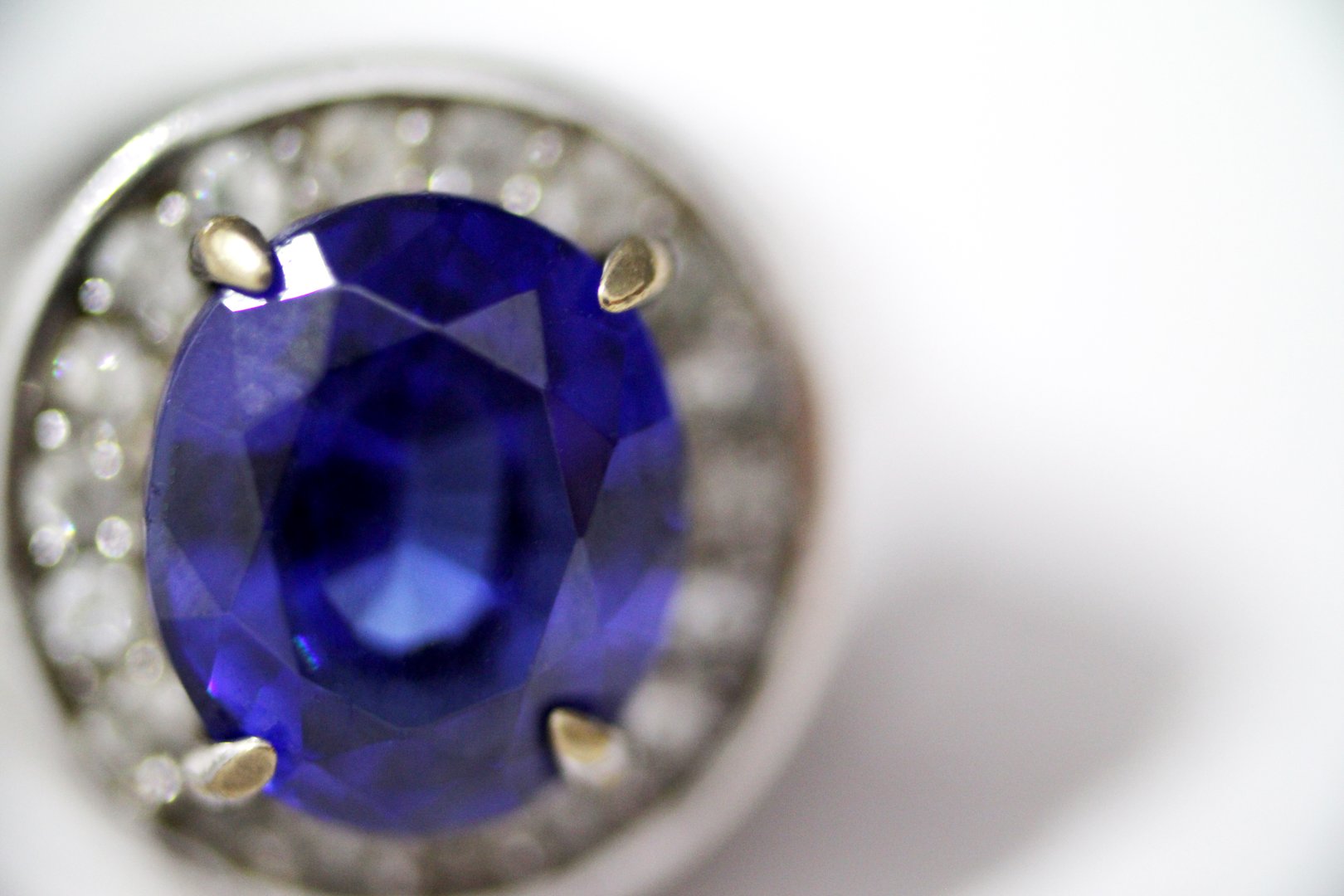 Vintage antique silver ring with blue sapphire gem stone on it, worn rusted look, blurred background