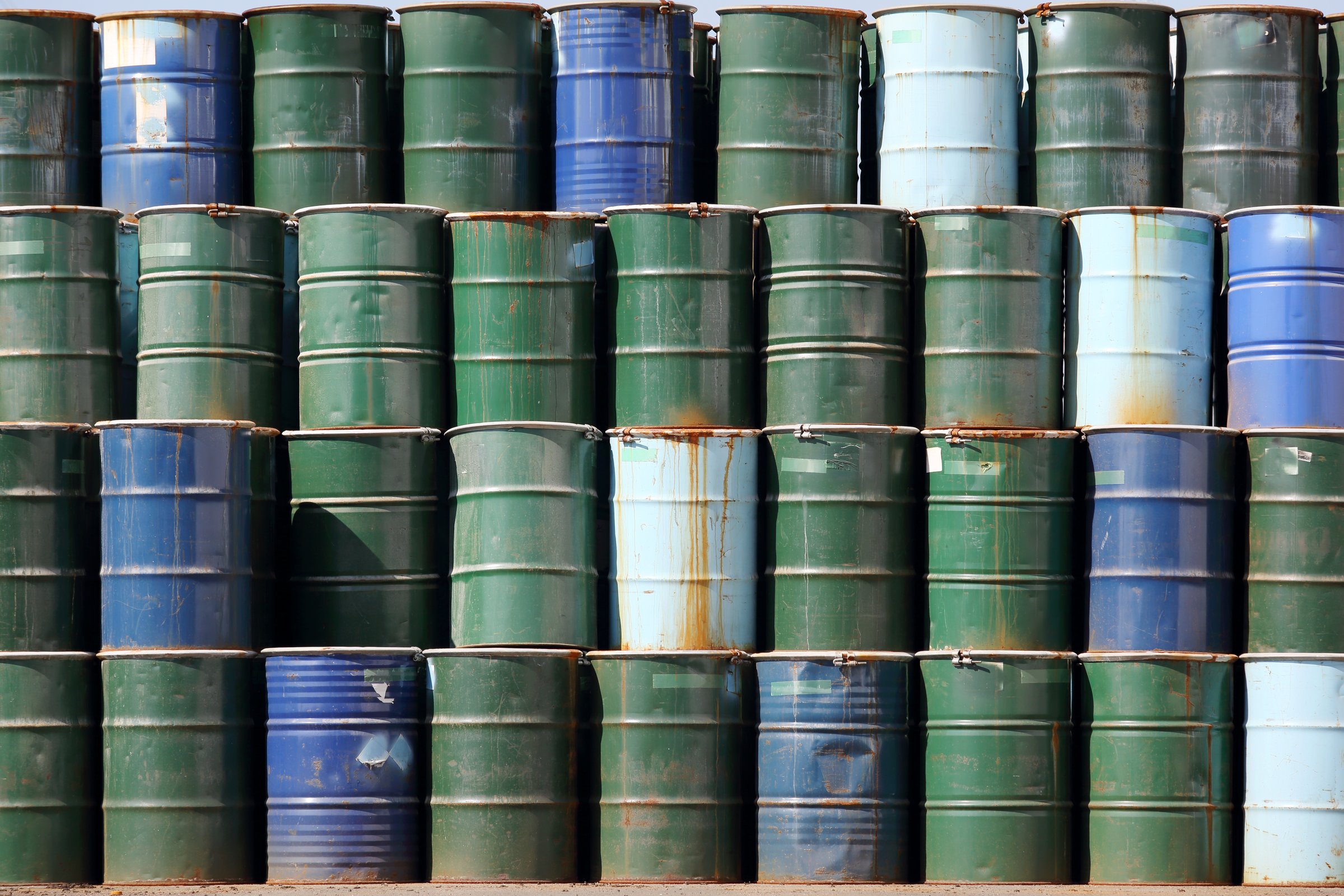 Stack of oil barrels — bitumen drum and barrel packaged shipping.