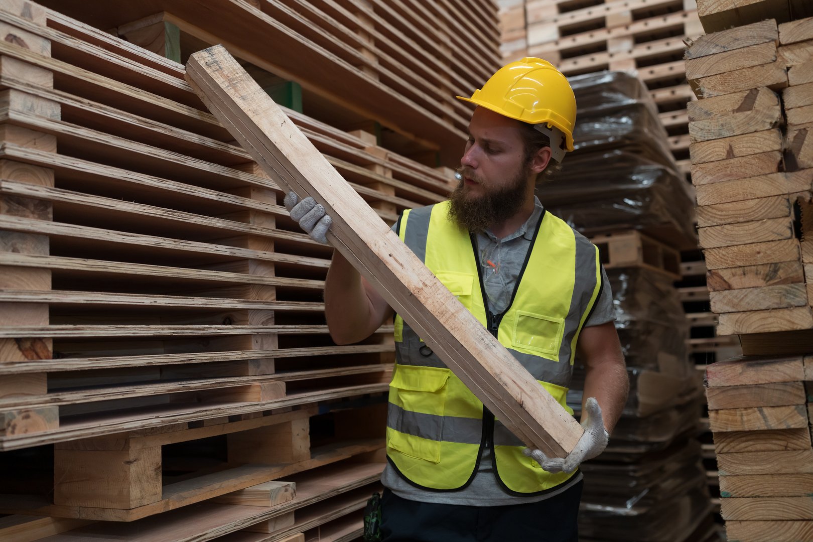 Male worker working in wooden warehouse storage. Male construction worker working at wooden warehouse