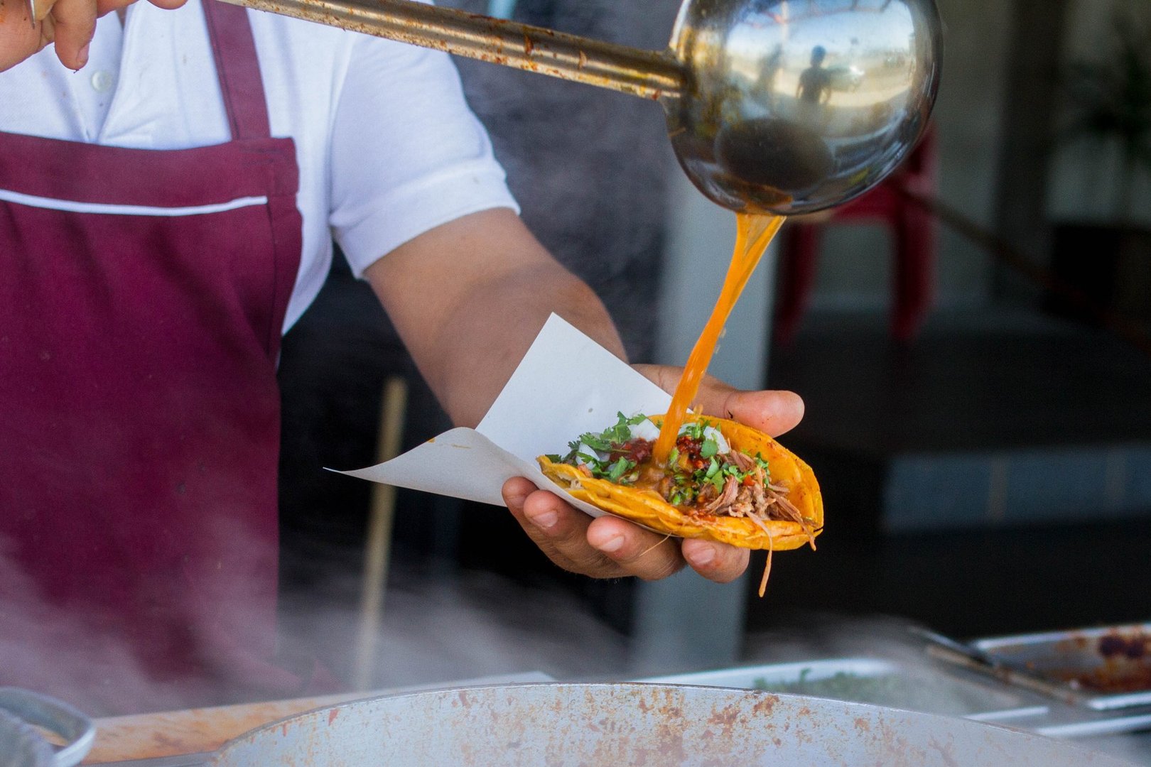Taco dorado de birria gets a spoonful of broth