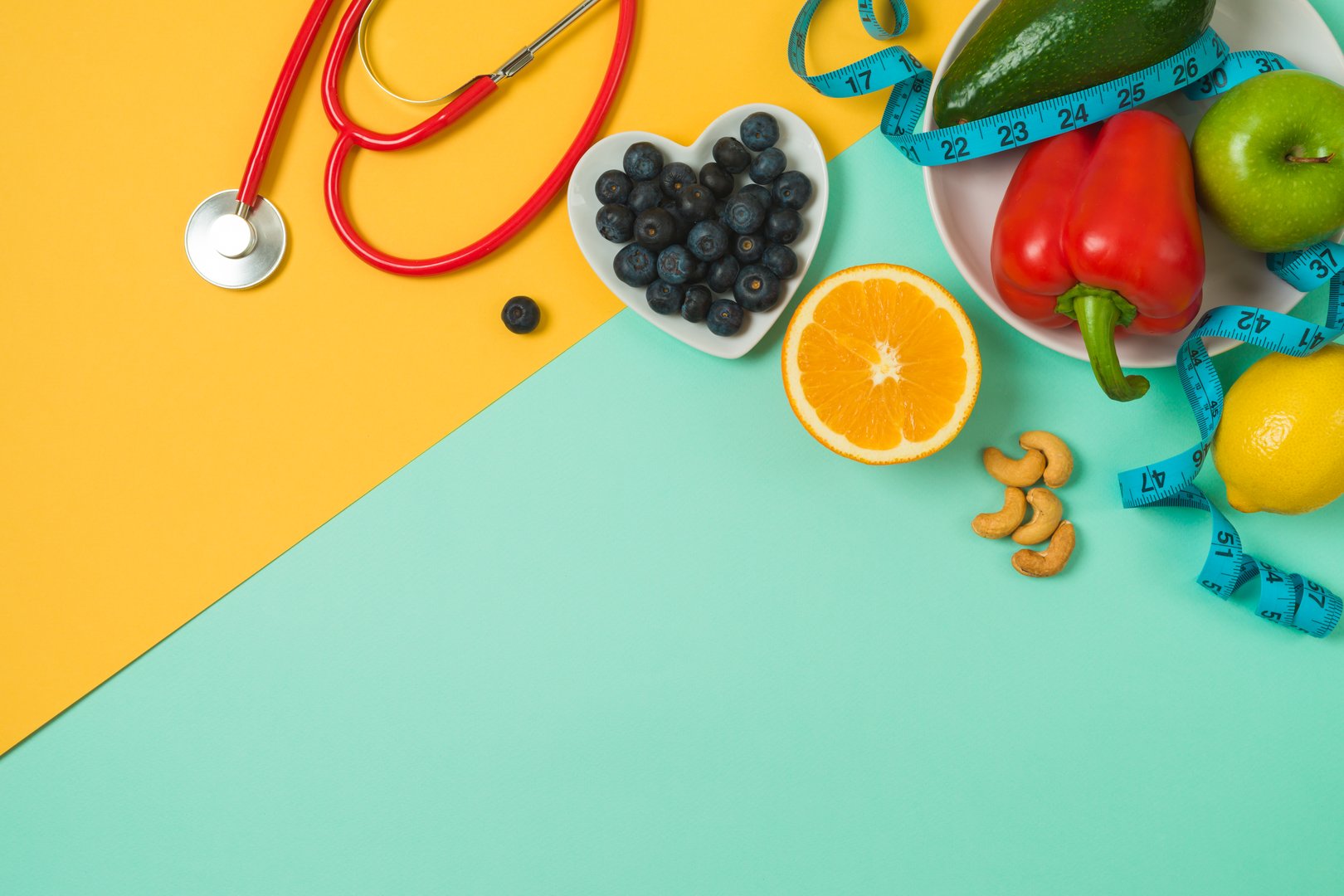 Healthy eating and lifestyle concept with fresh vegetables, fruits, blueberries and medical stethoscope