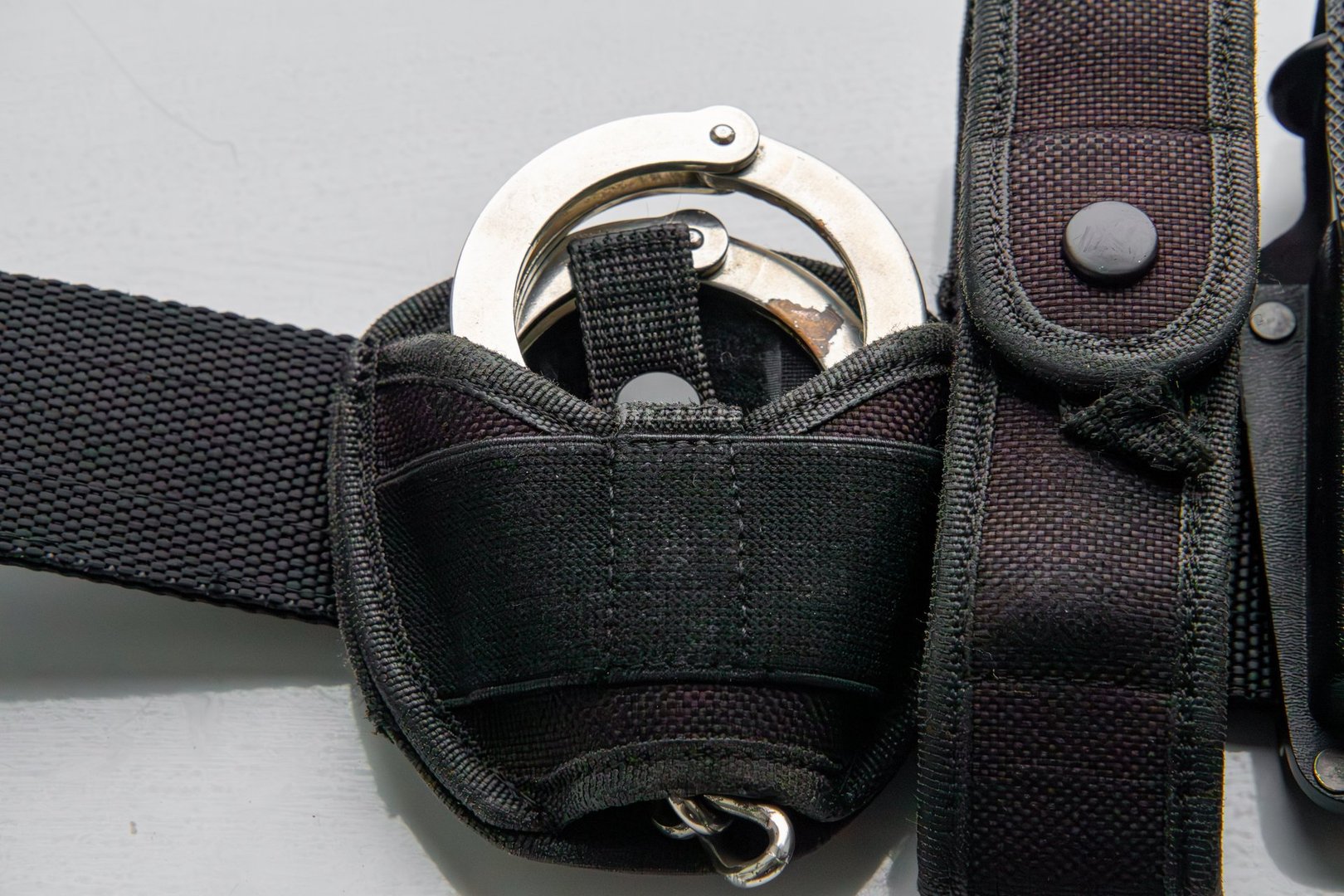 handcuffs in a holster on a tactical belt. means of direct coercion