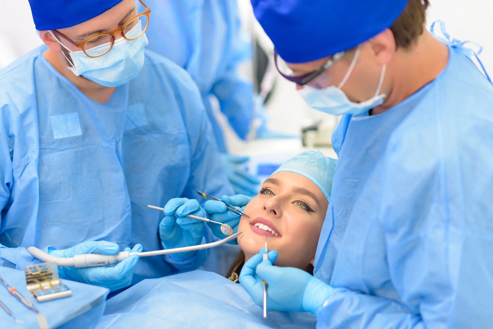Dentist doctor and his team treating a patient at clinic