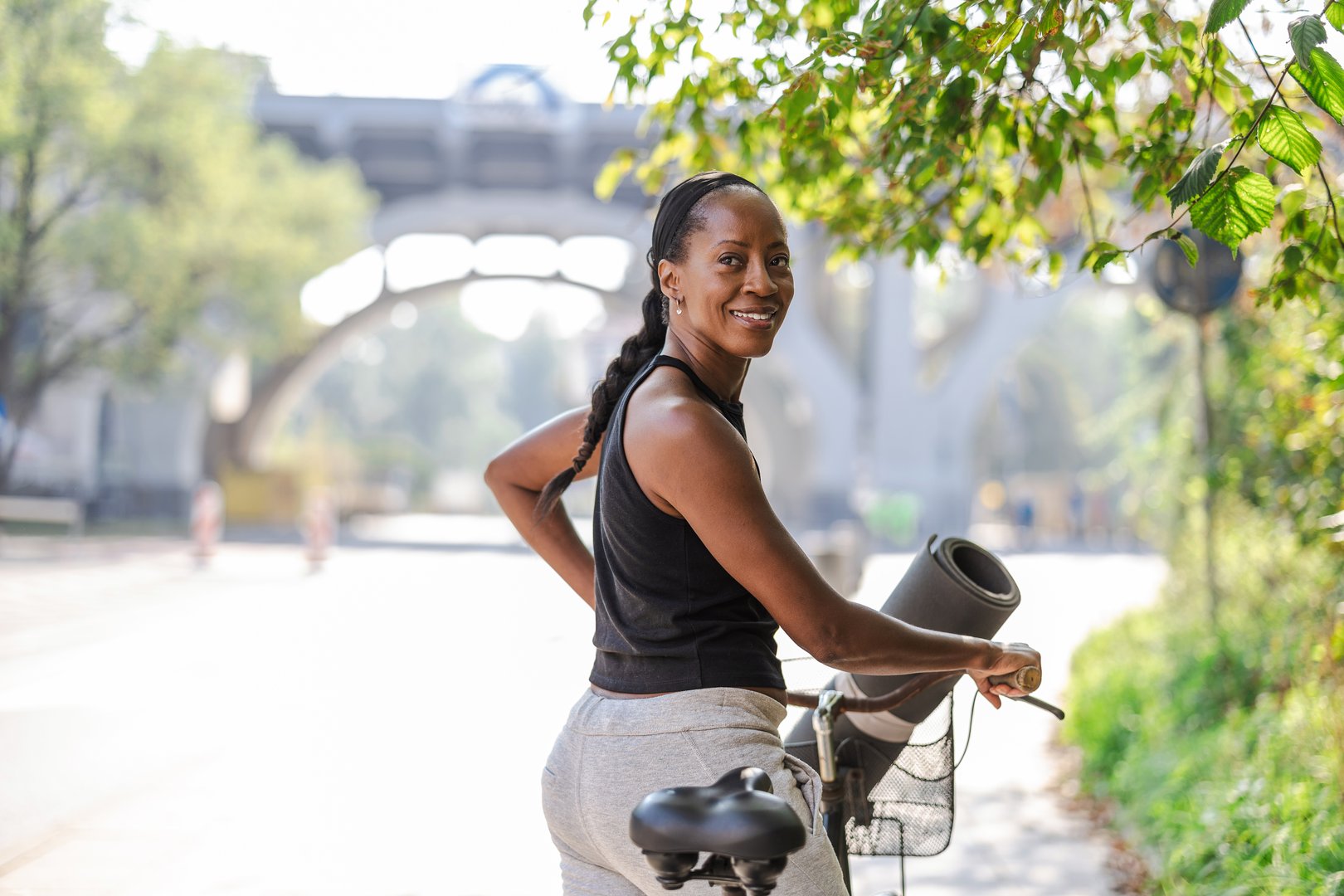 Portrait of a sporty woman with her bicycle in the city