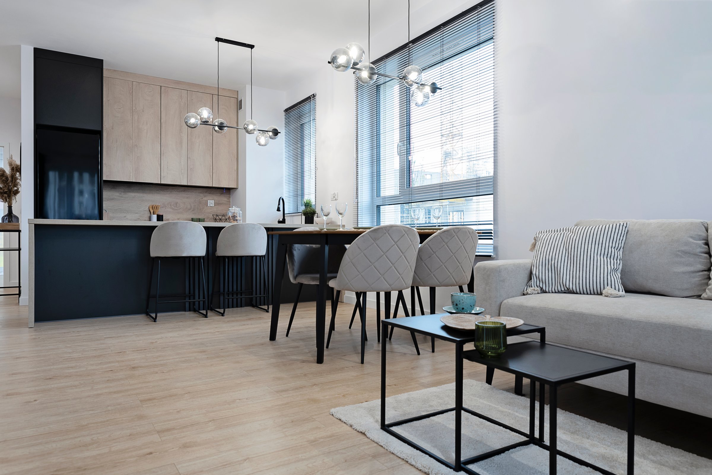 New apartment and home interior of living room with kitchen. Simplicity and flat design with wooden parquet floor.