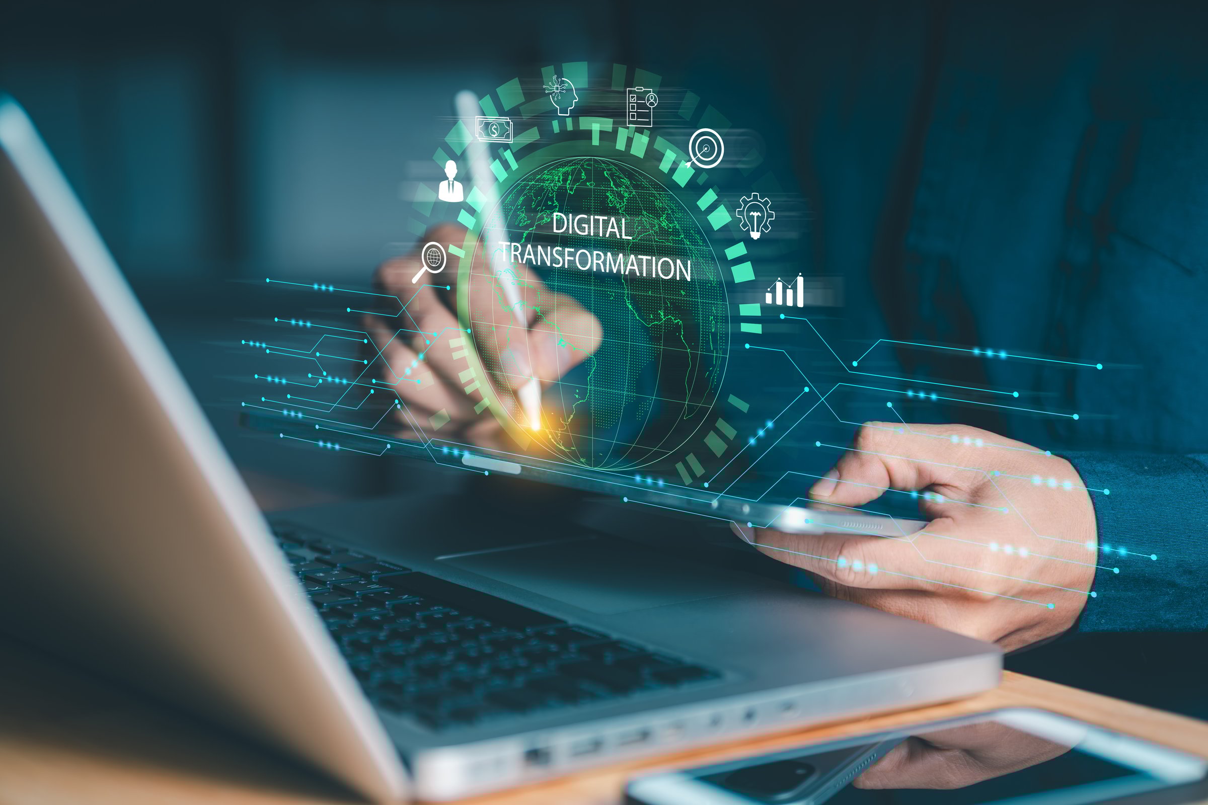 Person interacting with a tablet and laptop, featuring a glowing "DIGITAL TRANSFORMATION" sphere and business icons. Symbolizes applying technology for business evolution and data analysis