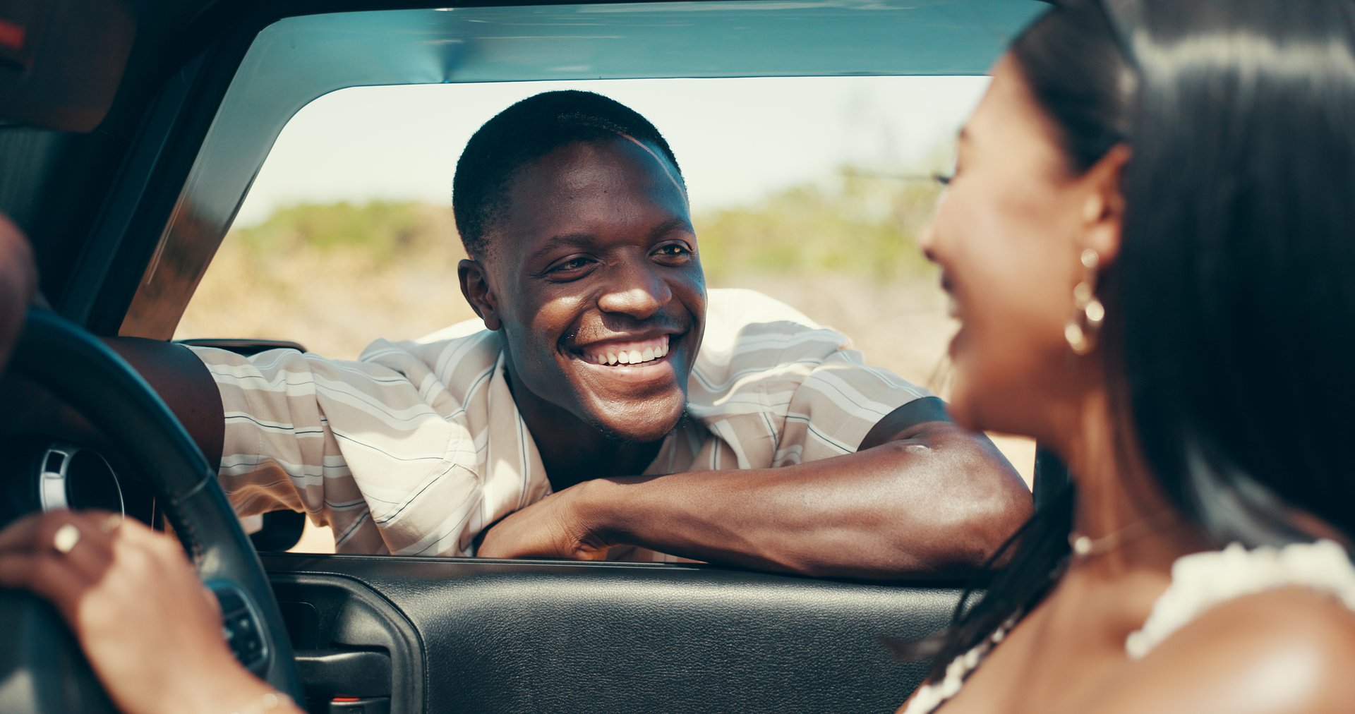 Man, woman and road trip with talking by window with smile, love and laugh on holiday in summer. People, couple and happy for journey, safari and travel with vehicle for transportation on vacation