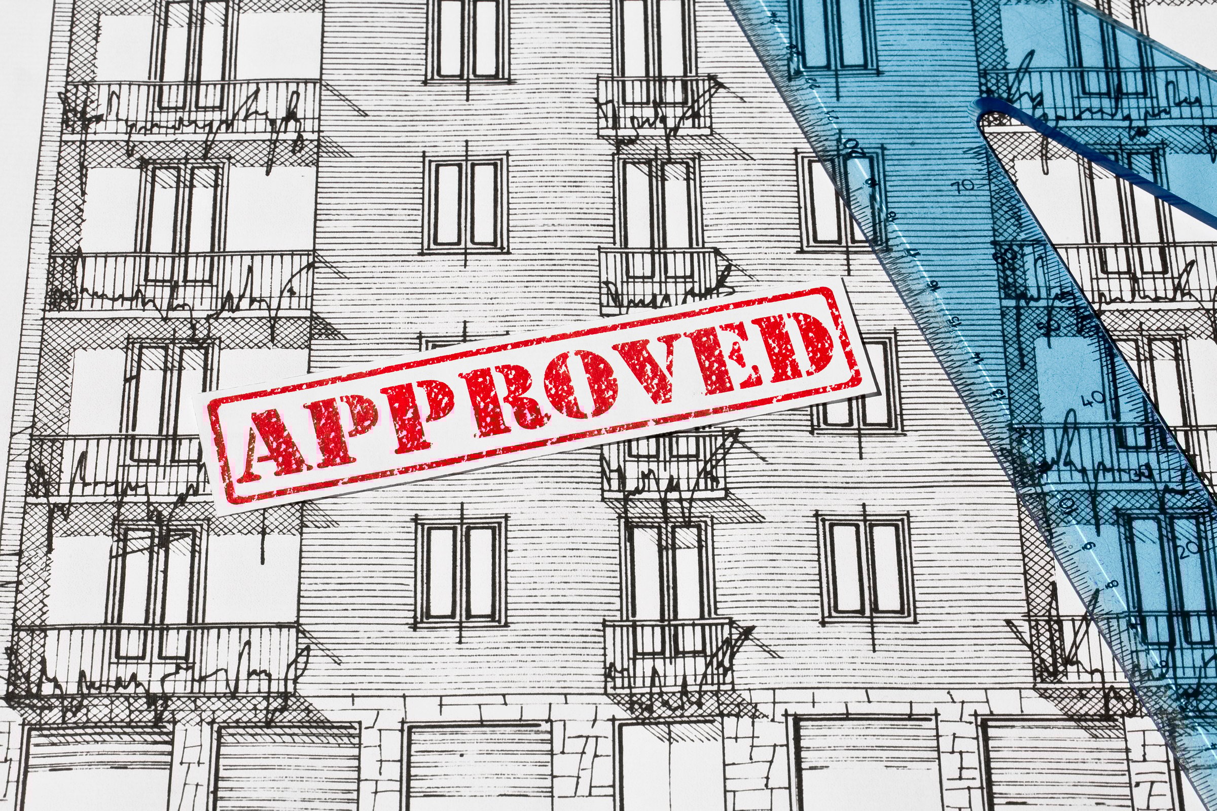 APPROVED BUILDING PERMIT DOCUMENT WITH ARCHITECTURAL BLUEPRINT of an old residential building - Concept of construction, real estate development, and planning approval