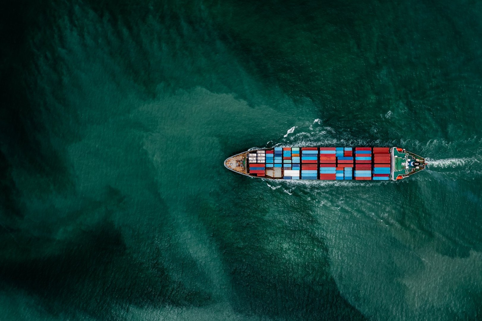 Container ship transporting cargo logistic to import export goods internationally around the world, including Asia Pacific and Europe, business and industry service of goods logistic transportation by container ship in sea concept, Aerial view