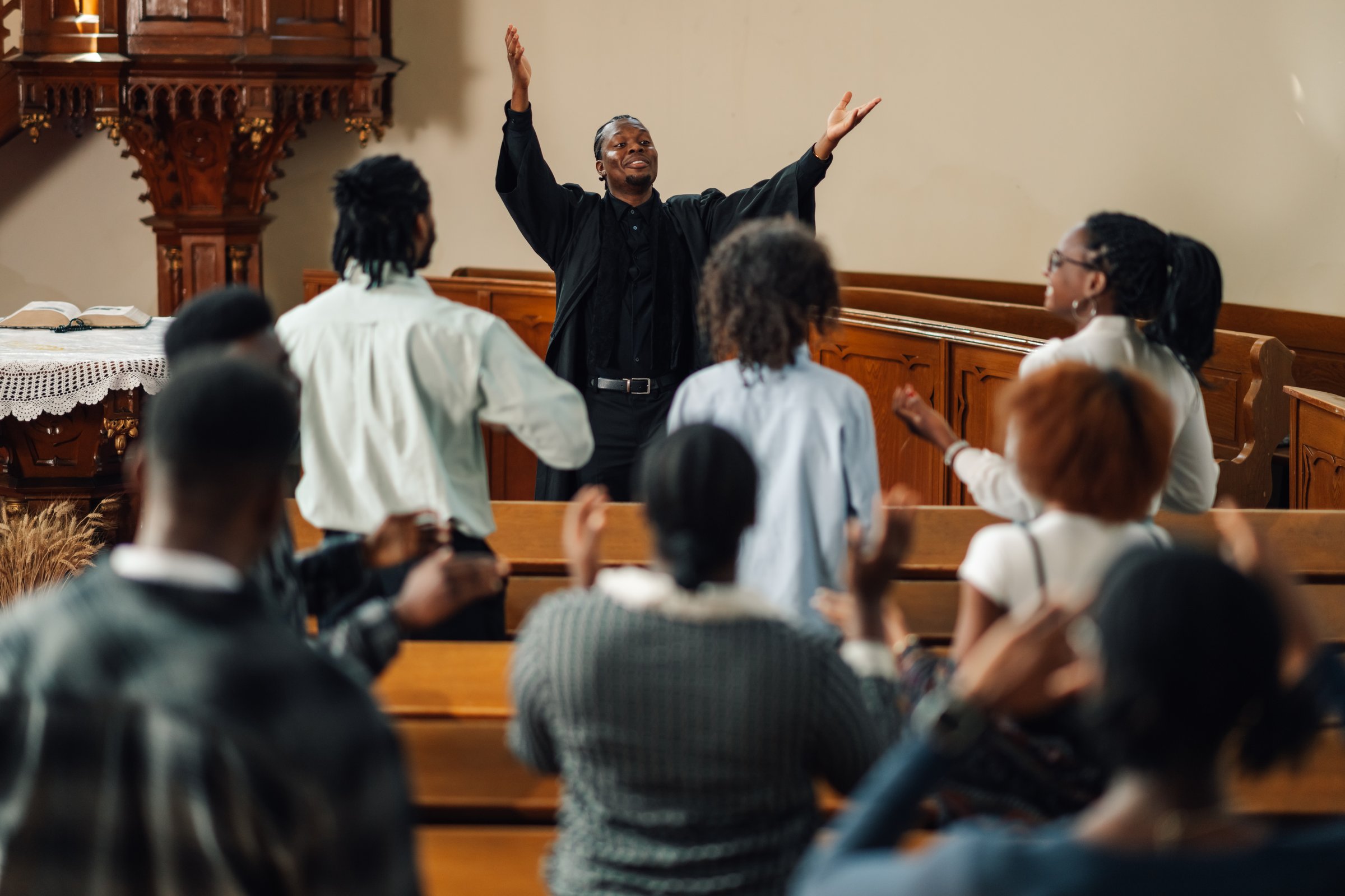 Pastor leading congregation in prayer