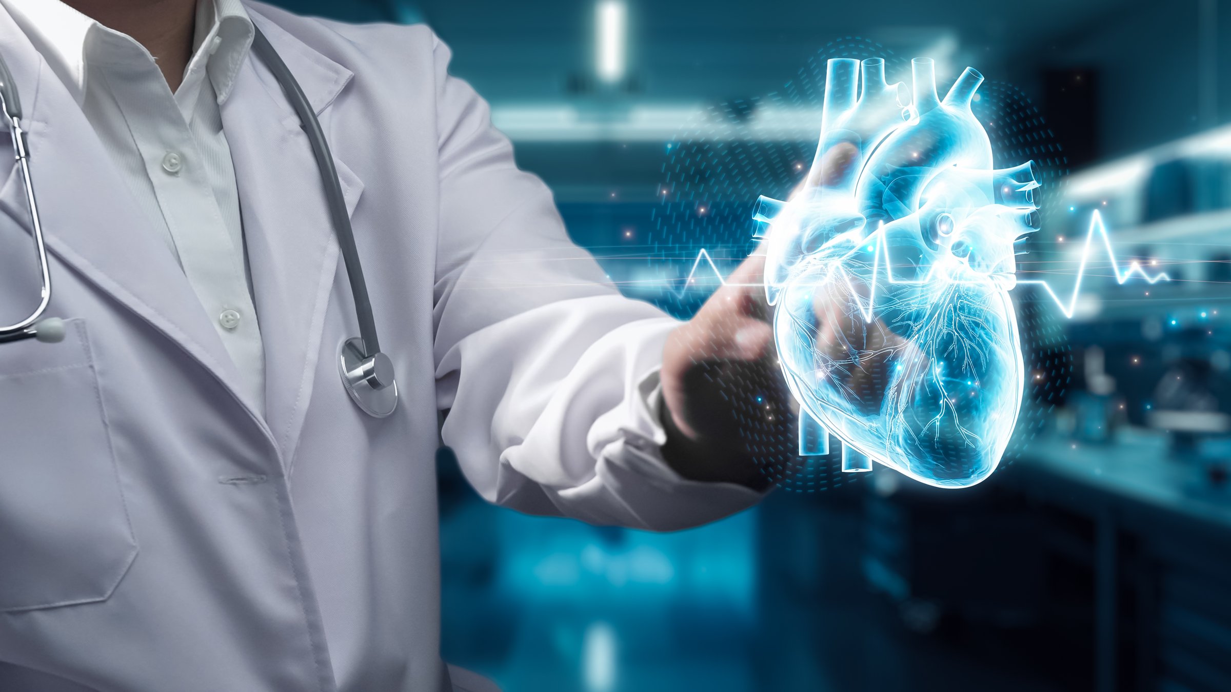 Close up of doctor standing and pointing at heart hologram floating at laboratory with blurring background. Medical worker checking and using technology innovation diagnosis heart disorder. Remedial.
