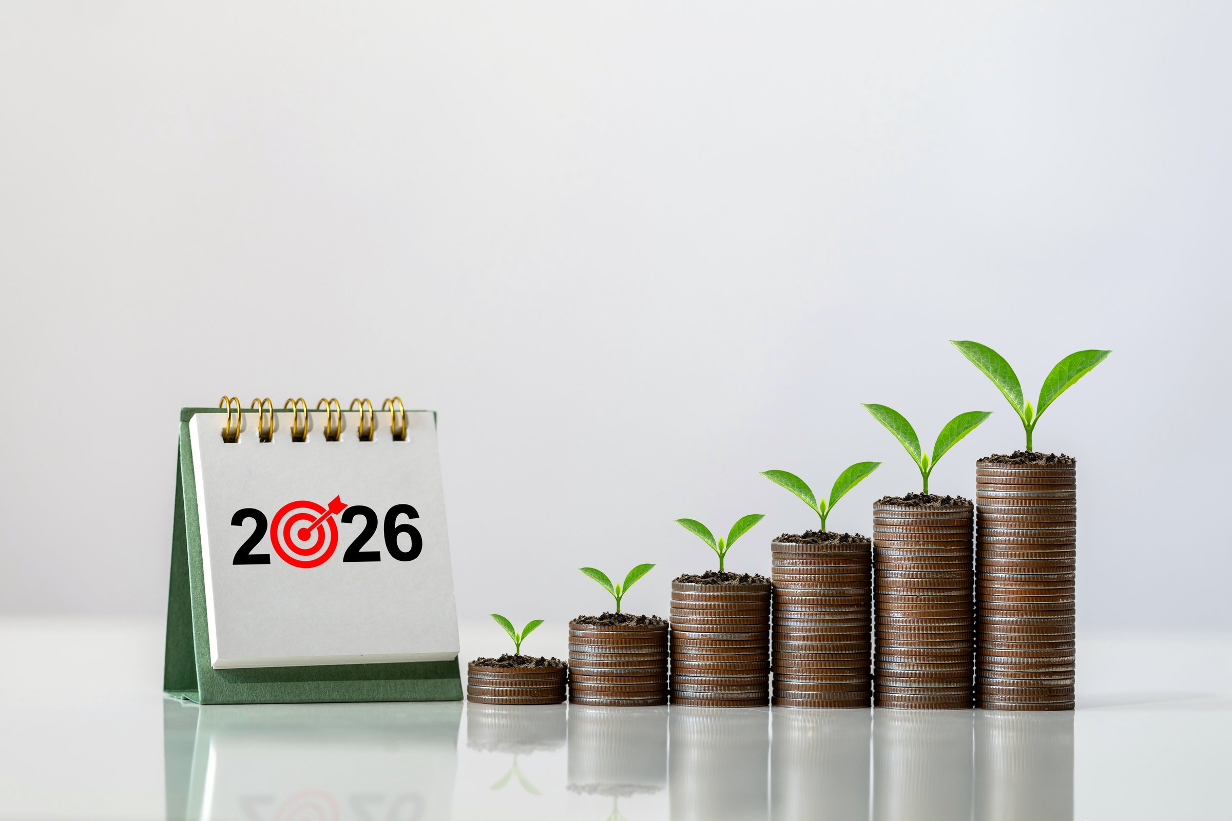 2026 desk calendar with stacks of coins symbolizing financial planning