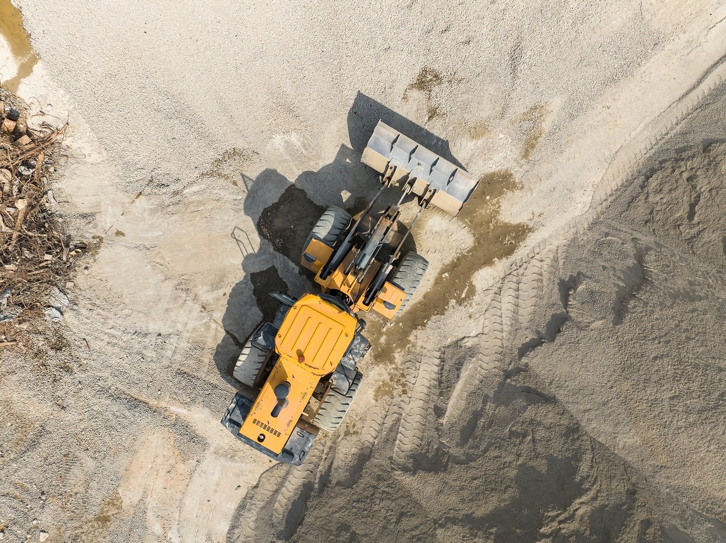 bulldozer on earthmoving at construction site, aerial view.