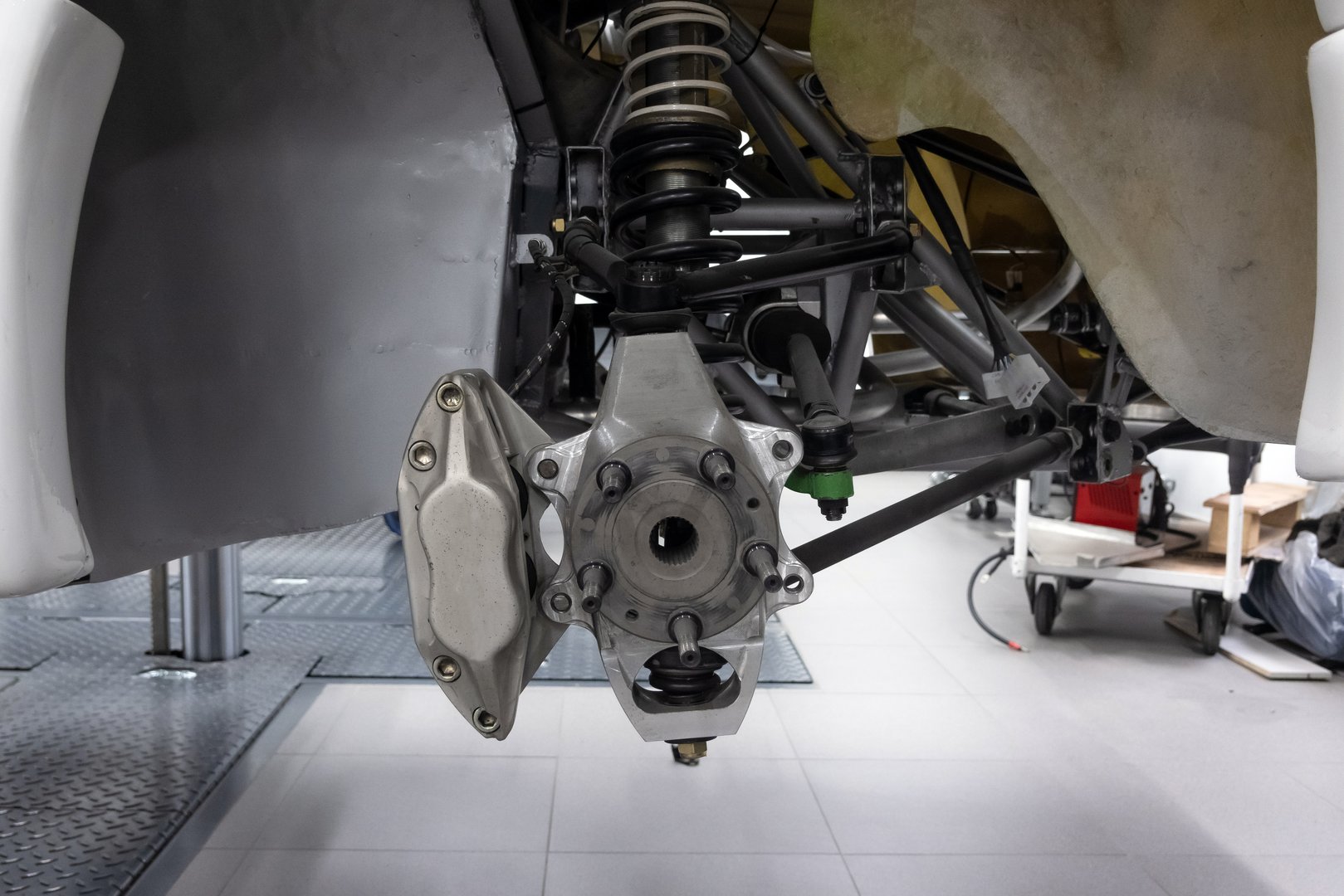 Replacing wheels on expensive sports car. Changing vehicle tire at the tire shop. The braking system of the car at auto service workshop.